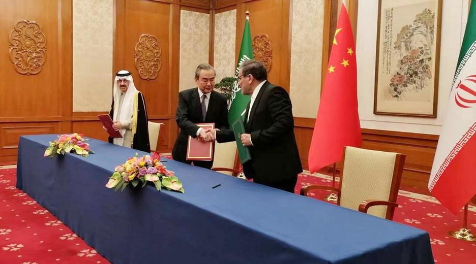 Der iranische Sekretär des Obersten Nationalen Sicherheitsrats Ali Shamkhani, der Direktor des chinesischen Büros der Zentralen Kommission für Auswärtige Angelegenheiten, Wang Yi, und der nationale Sicherheitsberater Saudi-Arabiens, Musaid Al Aiban, geben sich die Hand