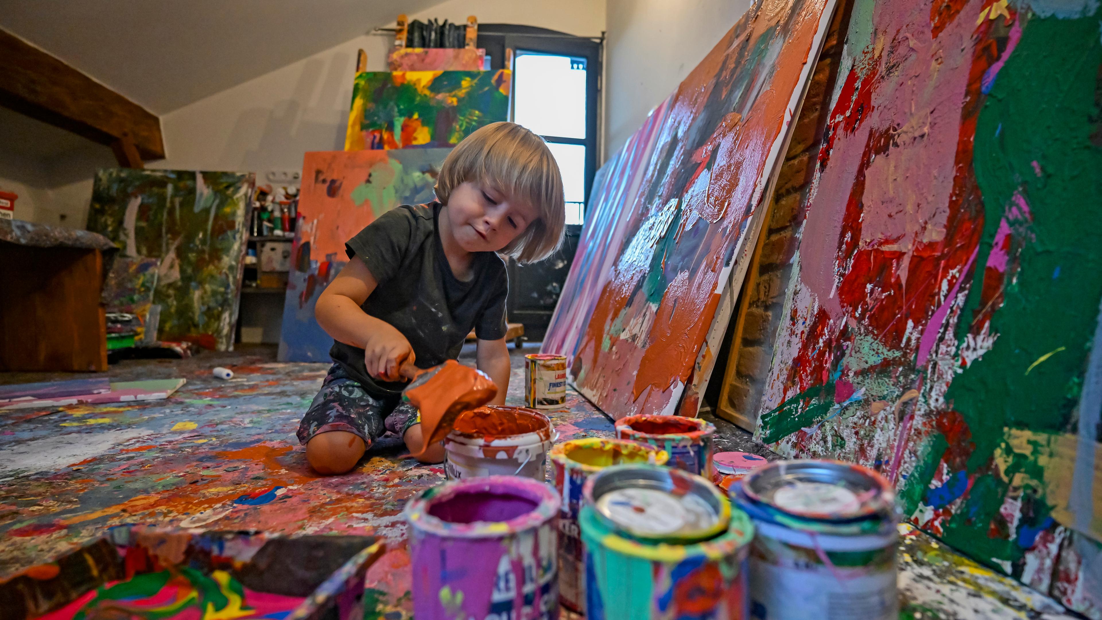 25.08.2024, Bayern, Neubeuern: Laurent Schwarz malt in seinem Atelier grossformatige Bilder mit Acrylfarben.