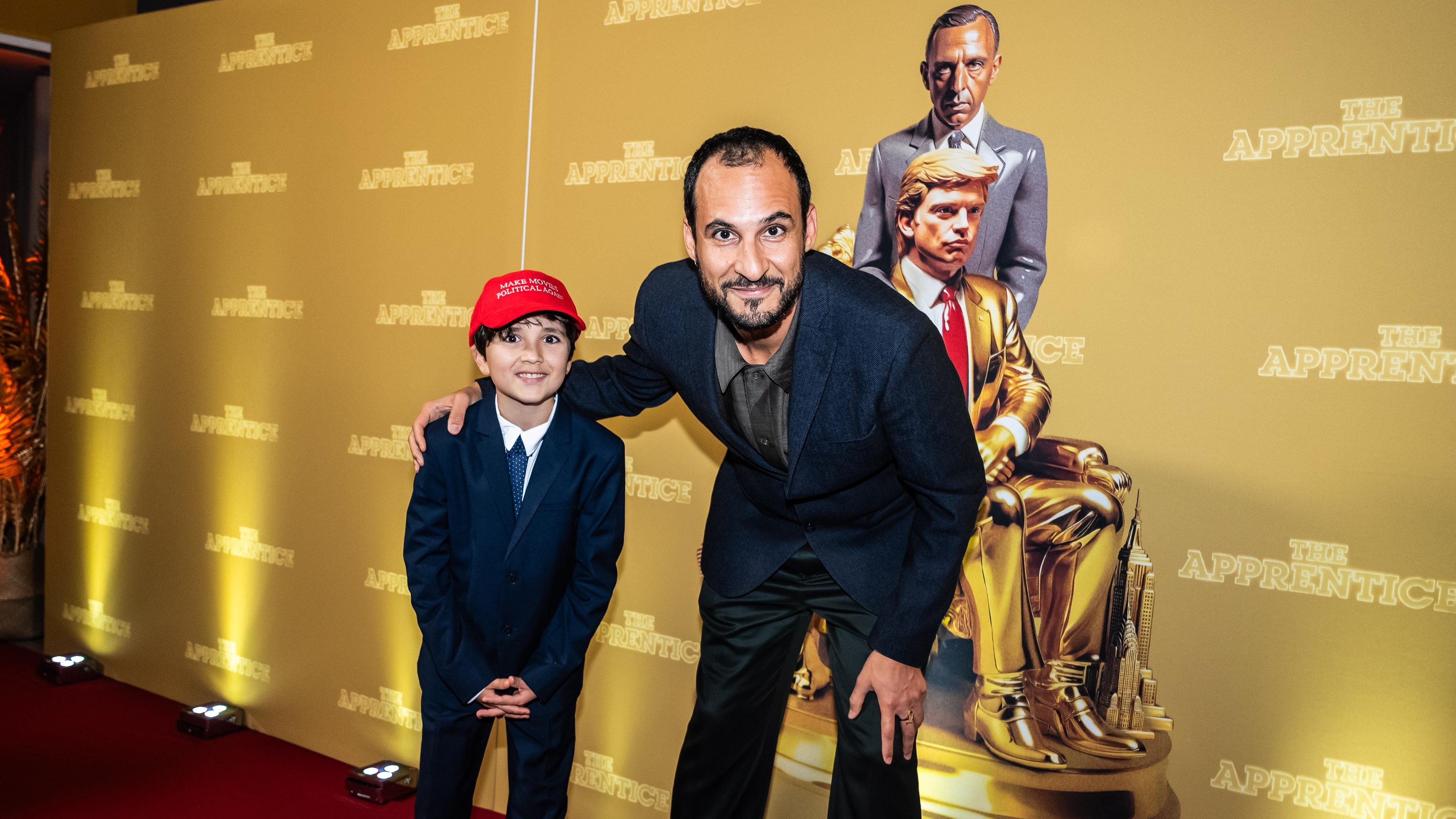 Iranian-Danish director Ali Abbasi poses with a young guest at the gala premiere for the film 'The Apprentice' at the Imperial in Copenhagen