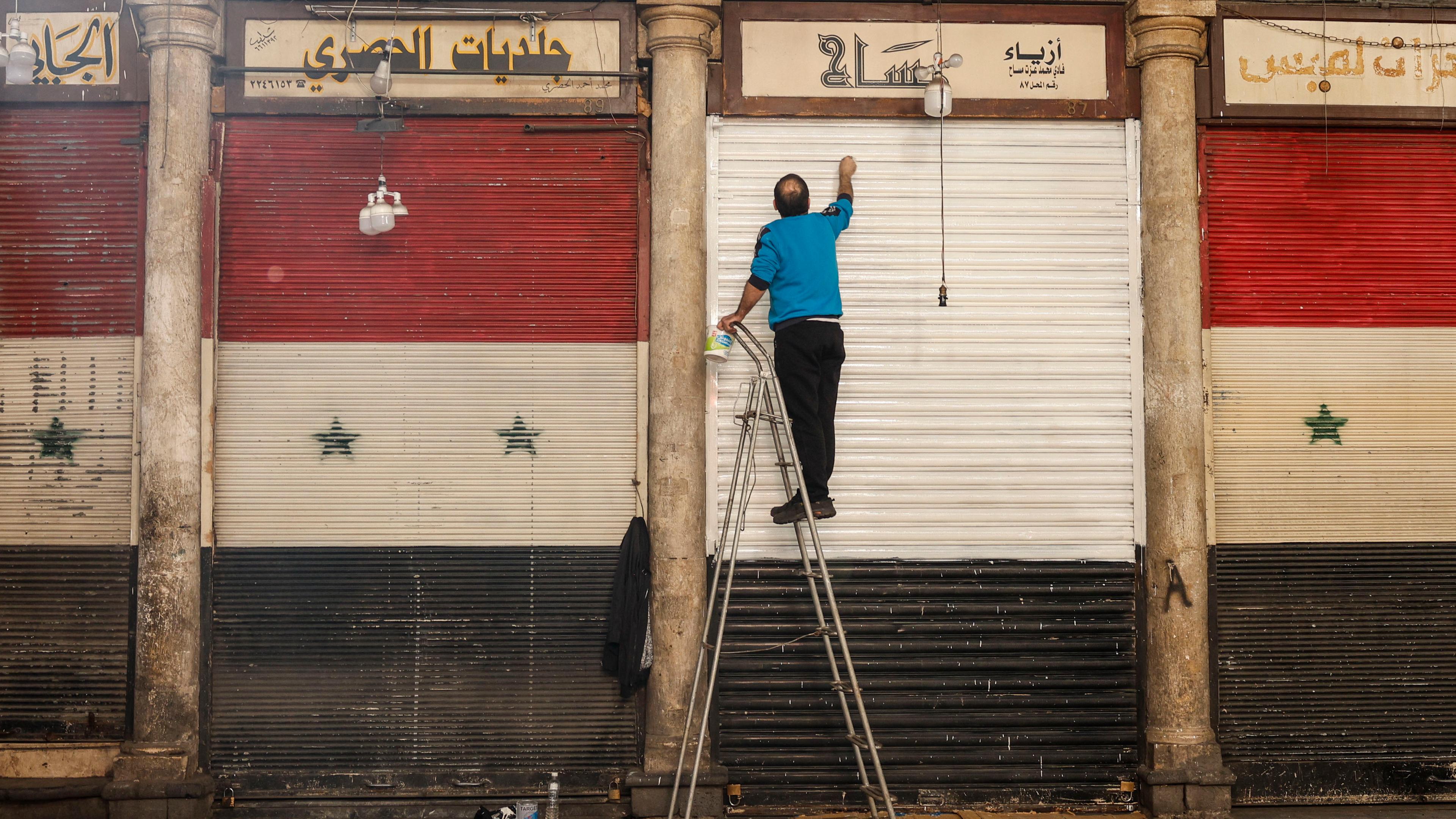 A man paints the railings of his establishment in Damascus, Syria, 13 December 2024. Hay'at Tahrir Al-Sham (HTS) leader Abu Mohammad Al-Jolani called on people across the country to celebrate 'the victory of the revolution' on 13 December, following the capture of Damascus and the overthrow of Bashar al-Assad