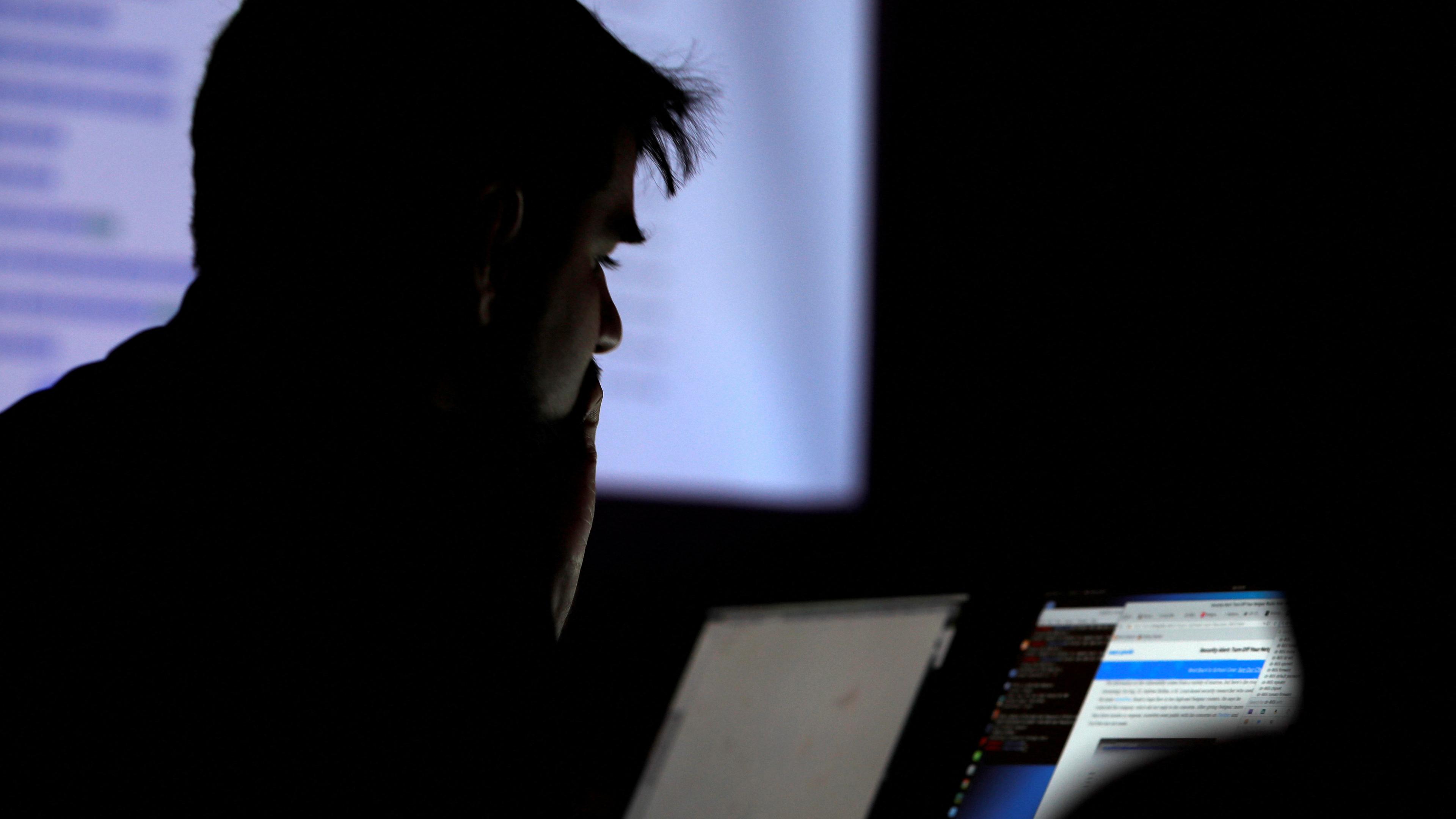 FILE PHOTO: A man takes part in a hacking contest during the Def Con hacker convention in Las Vegas