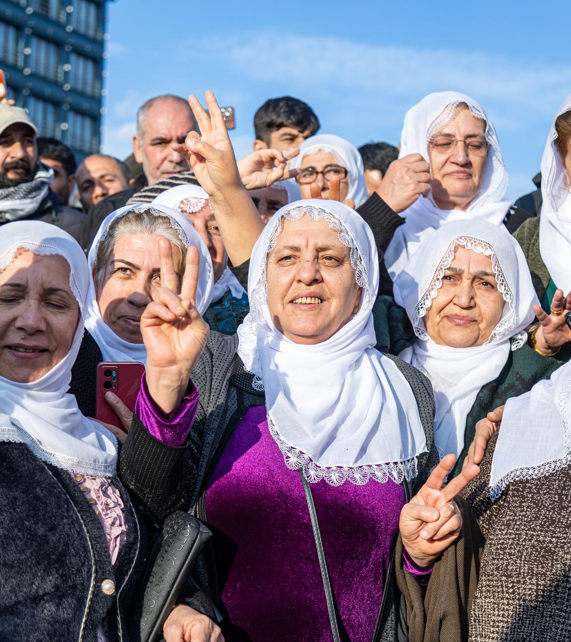 Anhänger der türkischen pro-kurdischen Partei für Gleichheit und Demokratie (DEM) feiern, während sie auf einem Bildschirm eine Pressekonferenz einer DEM-Delegation nach ihrem Besuch beim inhaftierten Führer der Arbeiterpartei Kurdistans (PKK), Abdullah Öcalan, in Diyarbakir, Türkei, am 27. Februar 2025 verfolgen. Auf der Pressekonferenz der DEM am 27. Februar wurde ein Brief des inhaftierten militanten PKK-Führers verlesen, in dem Abdullah Öcalan die kurdische Gruppe auffordert, ihre Waffen niederzulegen