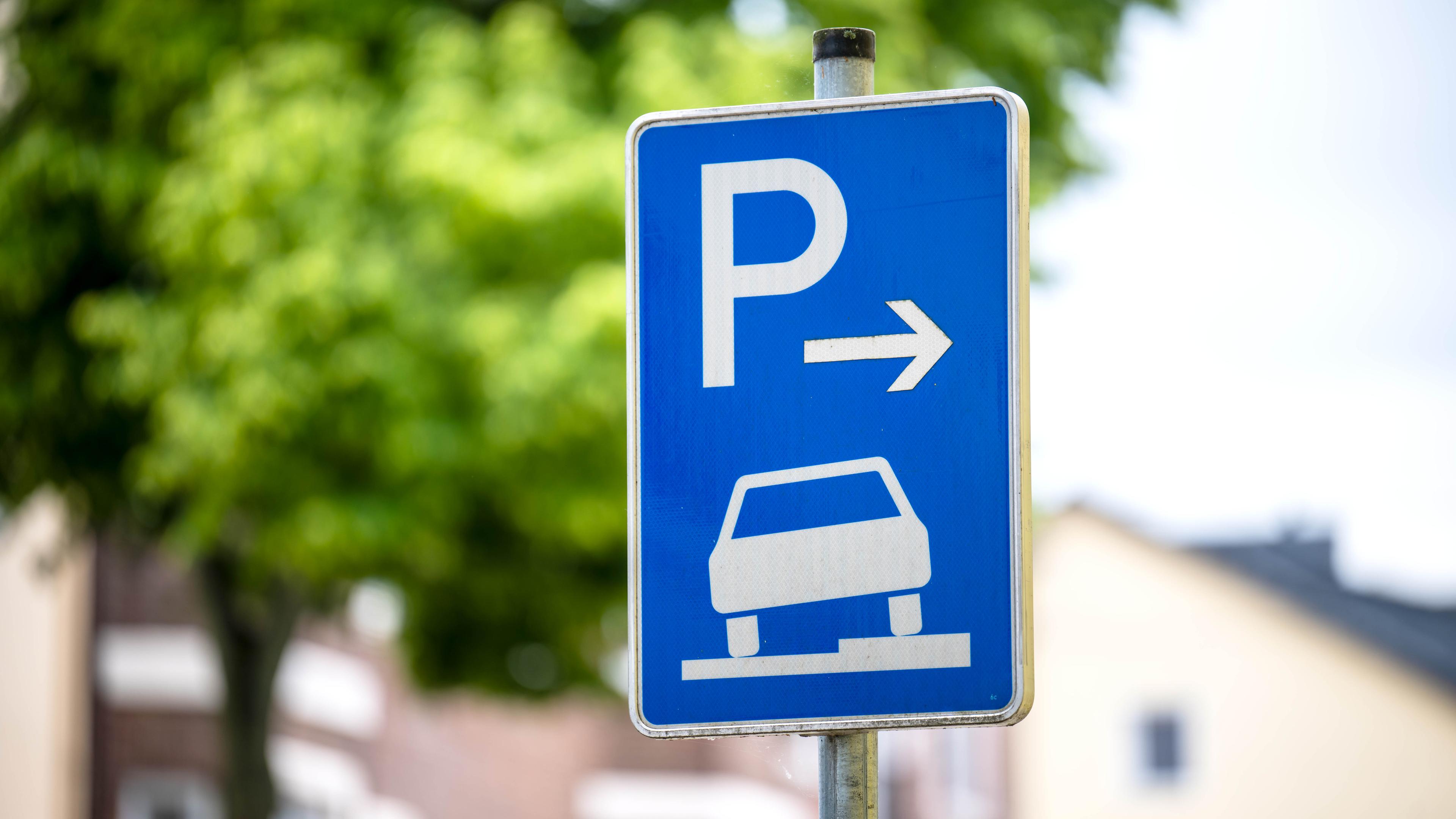 Ein Verkehrszeichen erlaubt das aufgesetzte Parken dem Gehweg. 
