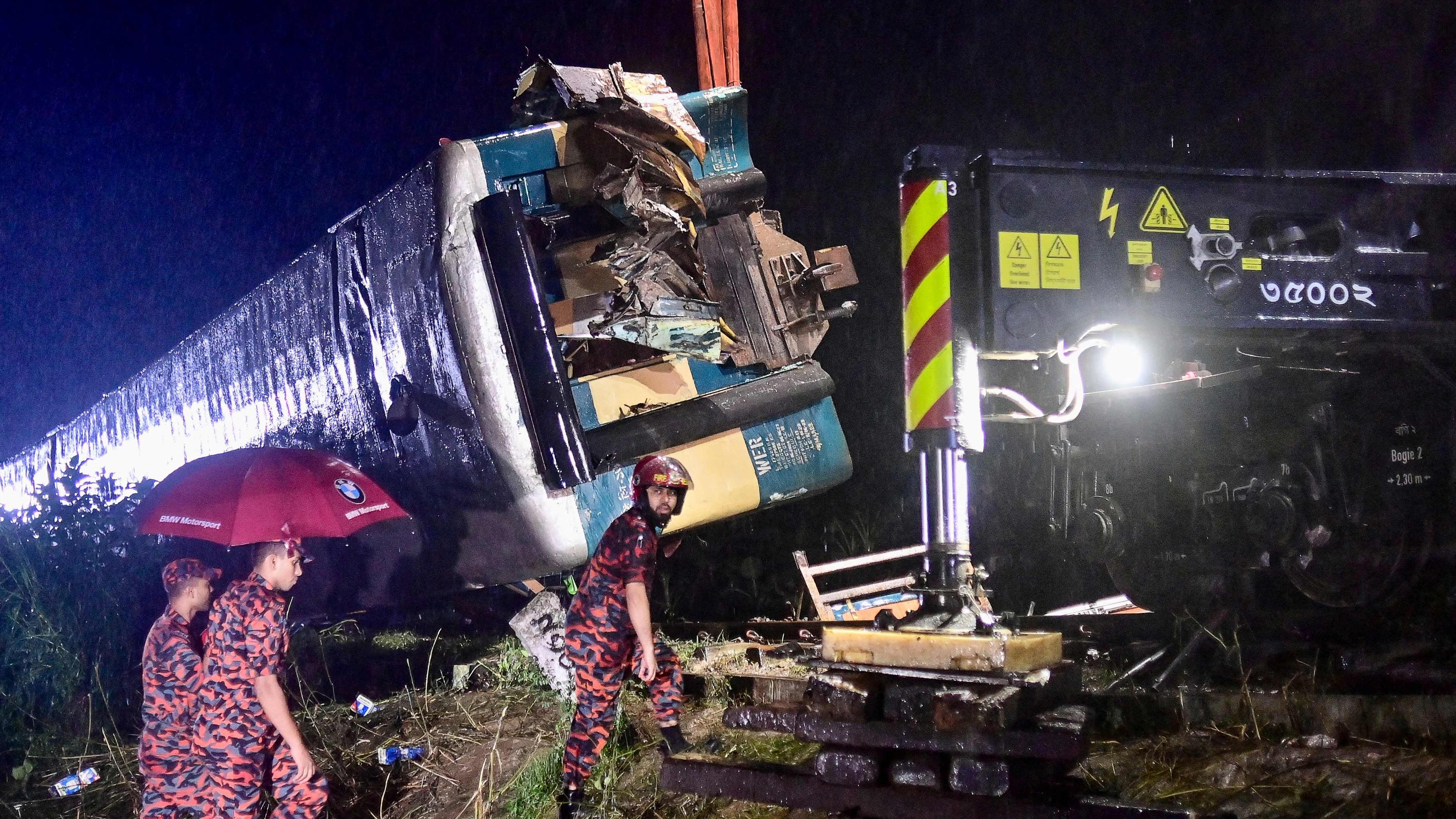 Rescue workers carry out a rescue operation after a passenger train collided with a freight train in Bhairab, some 85km east from Dhaka, on October 23, 2023. 