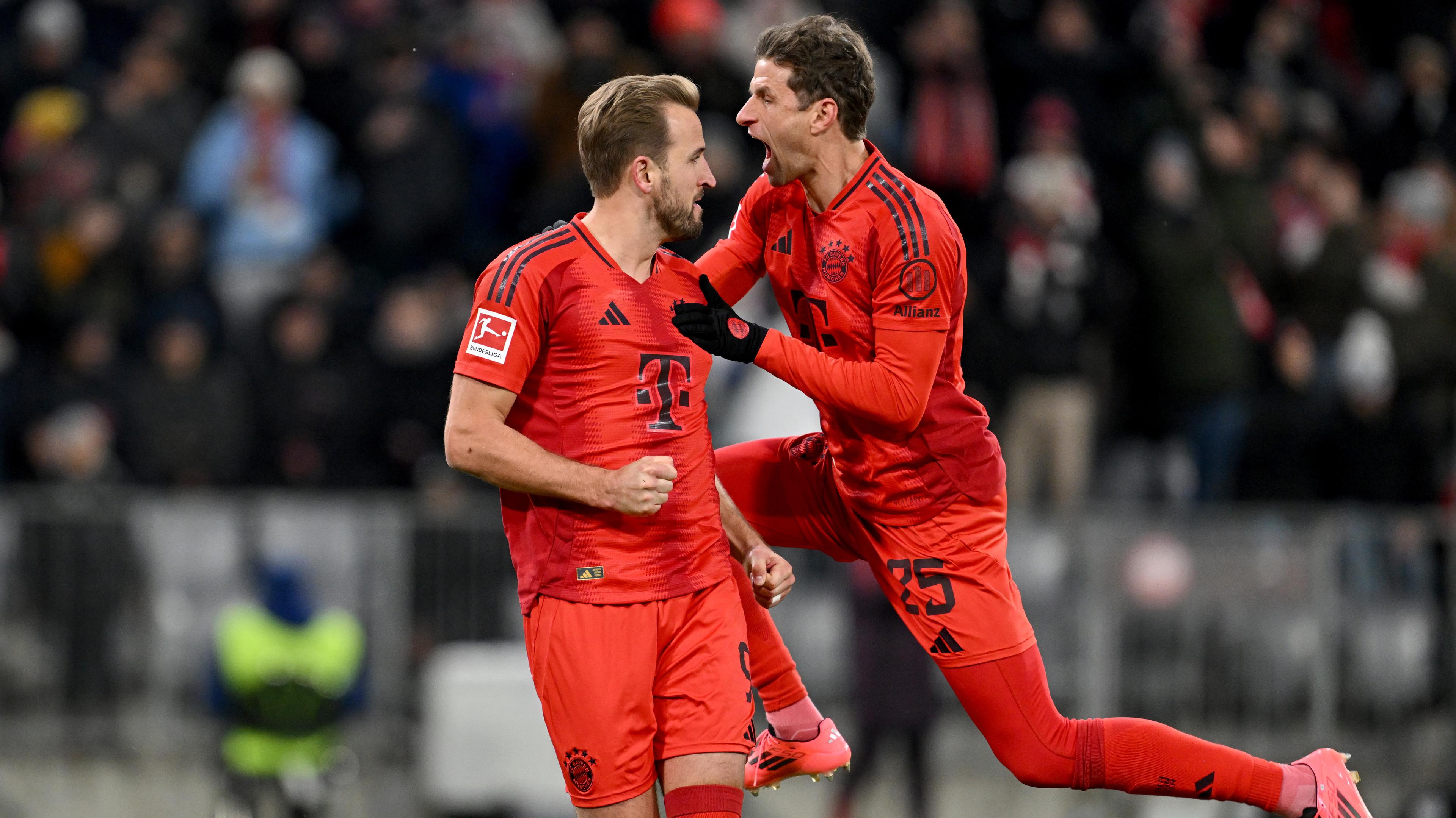 Bayern Münchens Harry Kane (l) bejubelt sein Tor zum 2:0 durch Foulelfmeter mit Bayern Münchens Thomas Müller.