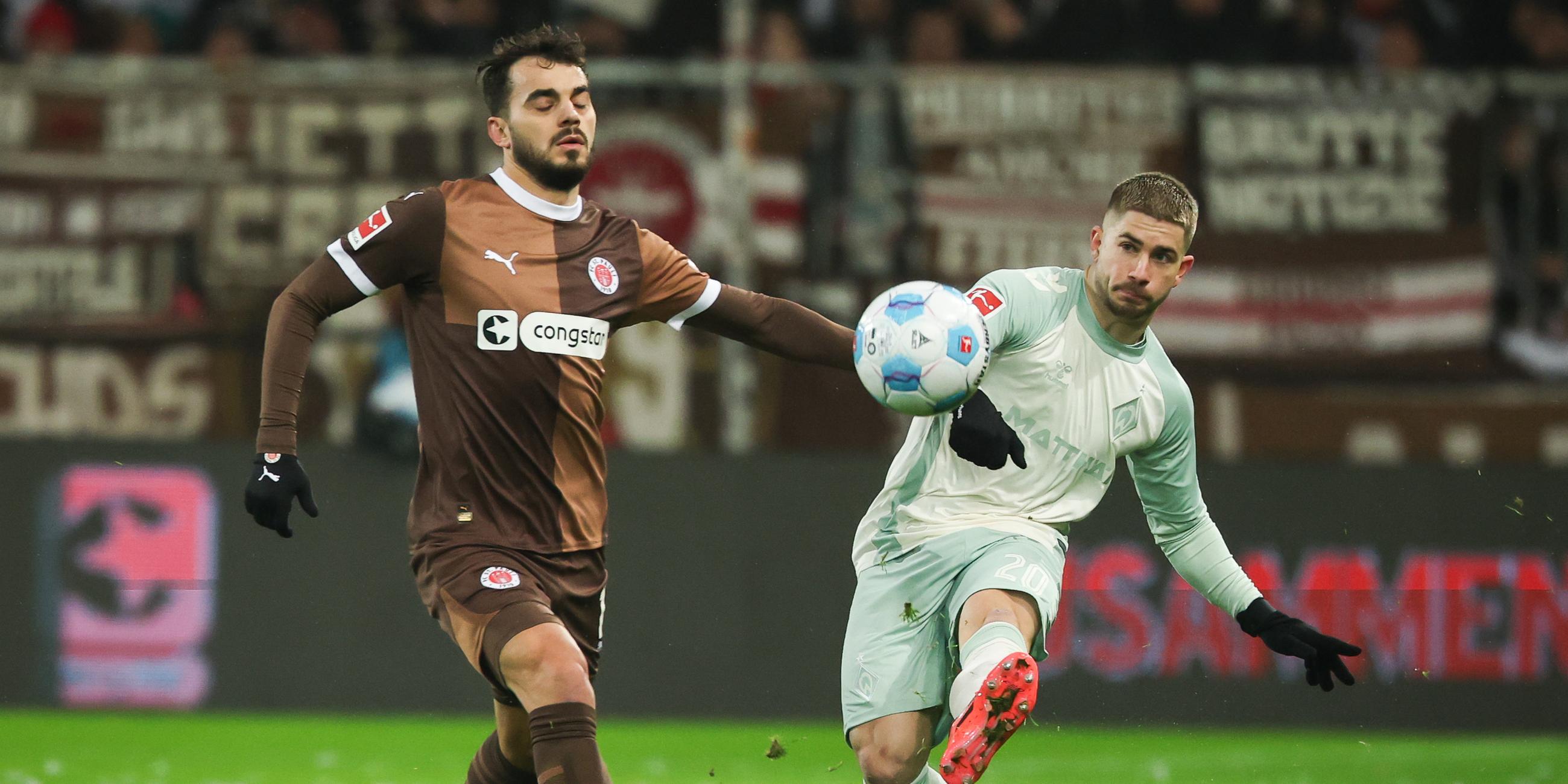 St. Paulis Daniel Sinani und Bremens Romano Schmid im Kampf um den Ball.