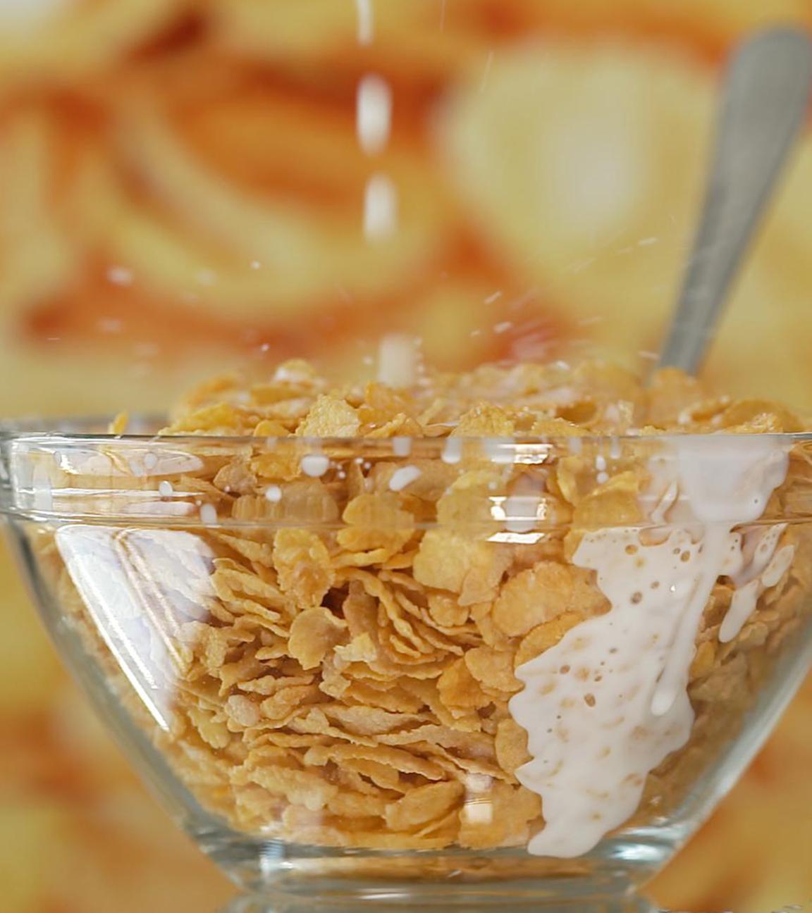 Cornflakes in einer Glasschale mit Milch oder Milchersatzprodukt