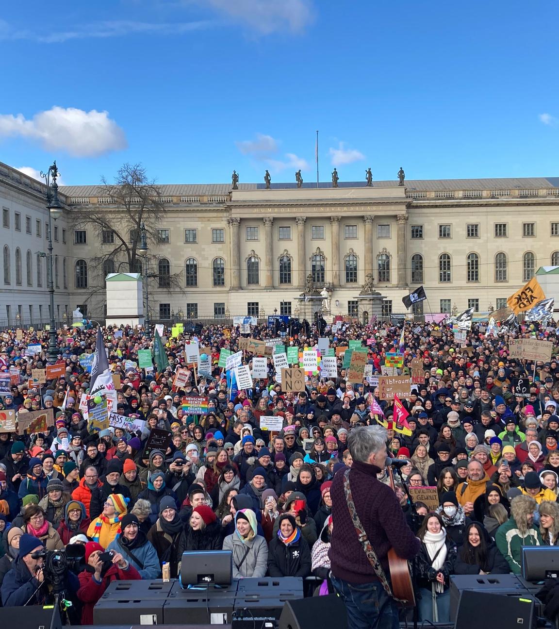 Demonstrierende mit bunten Plakaten in Berlin