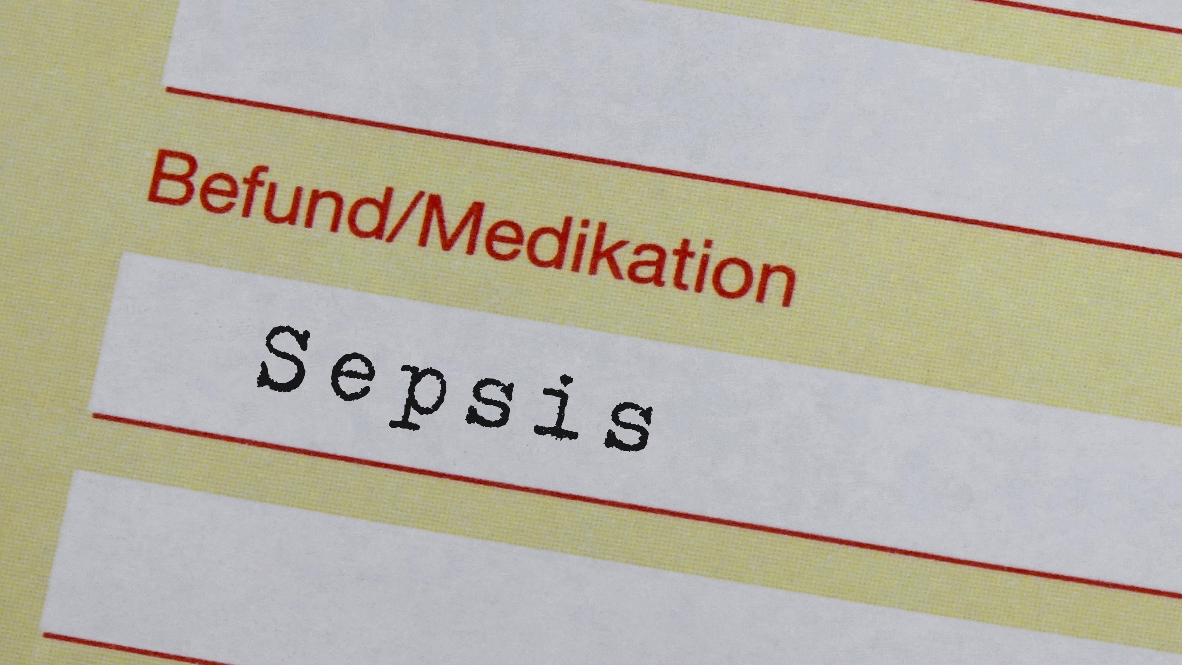 Eine gelbe Arbeitsunfähigkeitsbescheinigung, auf der die Diagnose Sepsis vermerkt ist.