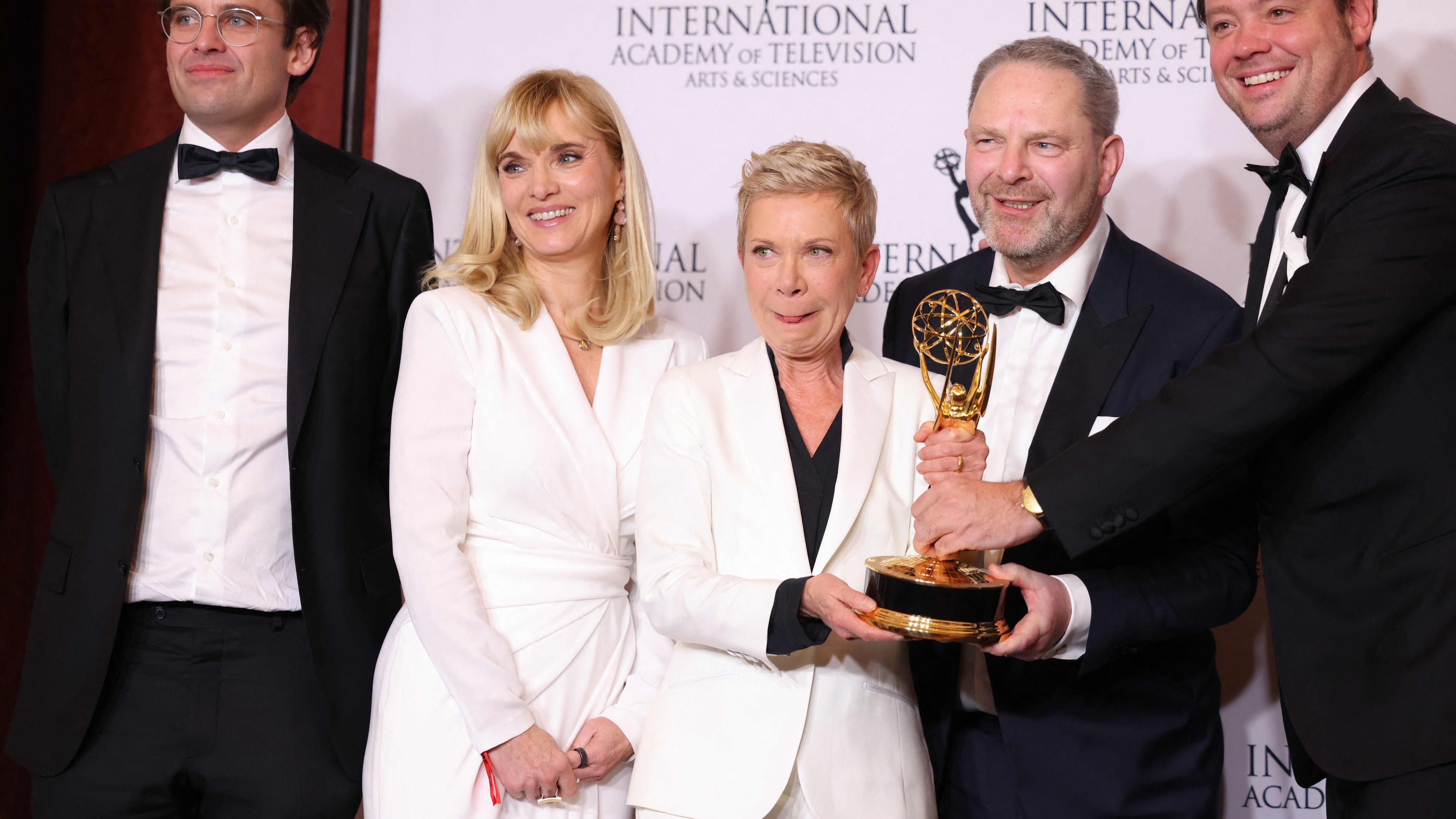 German director Isabel Kleefeld (C) and producer Friedrich Oetker (R) pose with the TV Movie/Mini-Series award for "Liebes Kind [Dear Child]