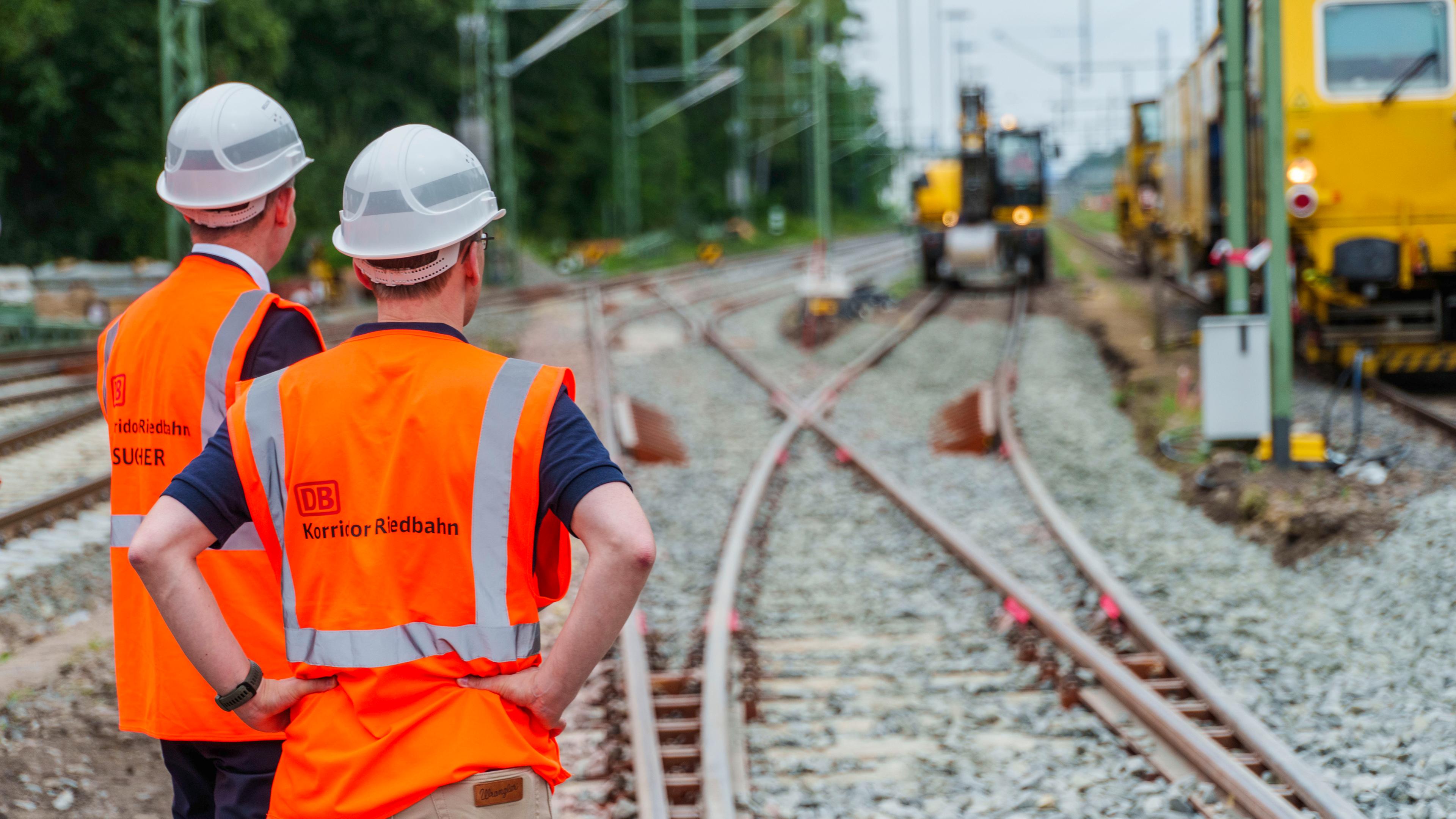 Bauarbeitende bei der Sanierung der Riedbahn auf den Bahngleisen.