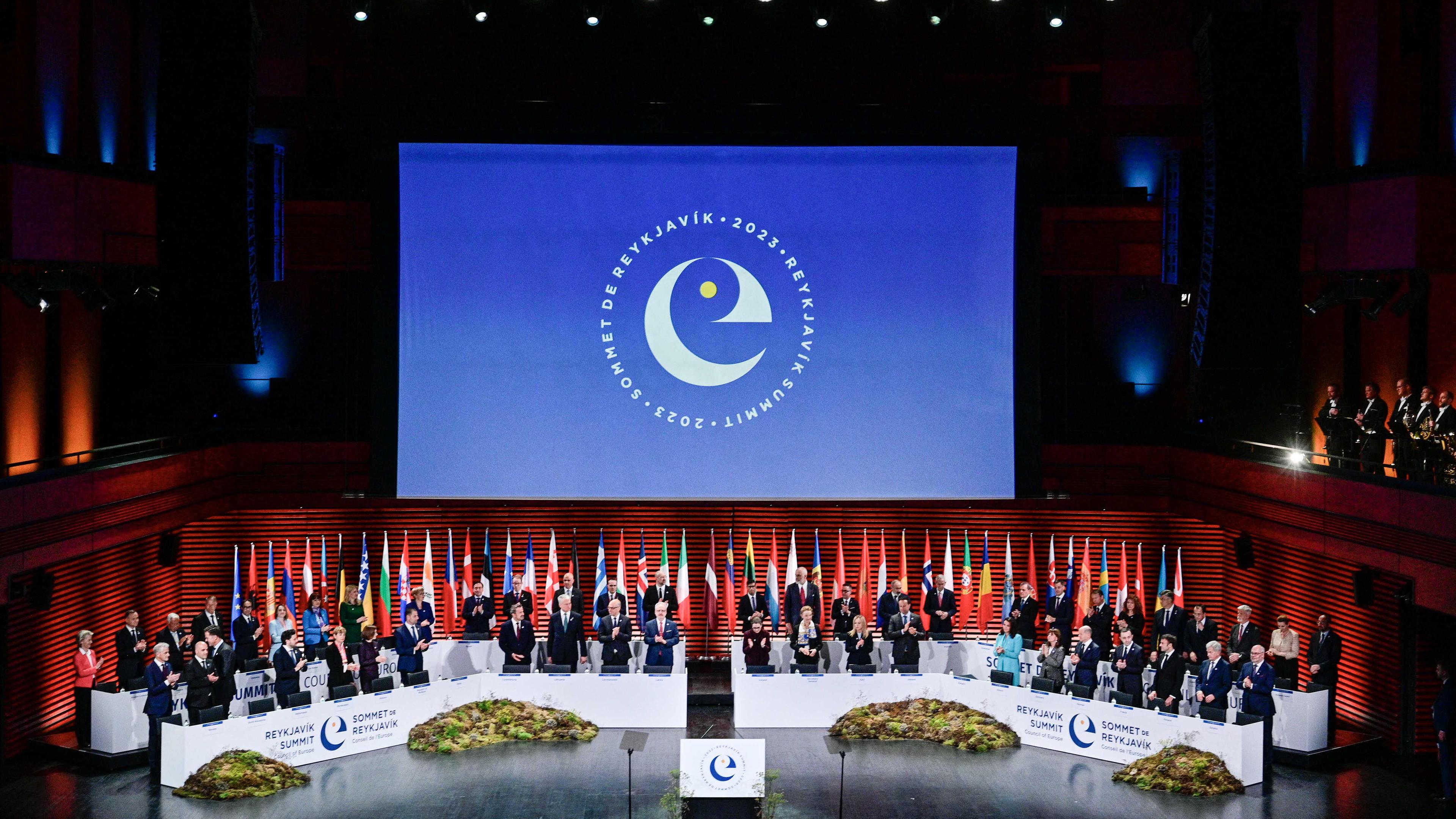 Eine Großaufnahme vom Rednerpult beim Gipfel des Europarats. Links und rechts sitzen VertreterInnen von verschiedenen Staaten