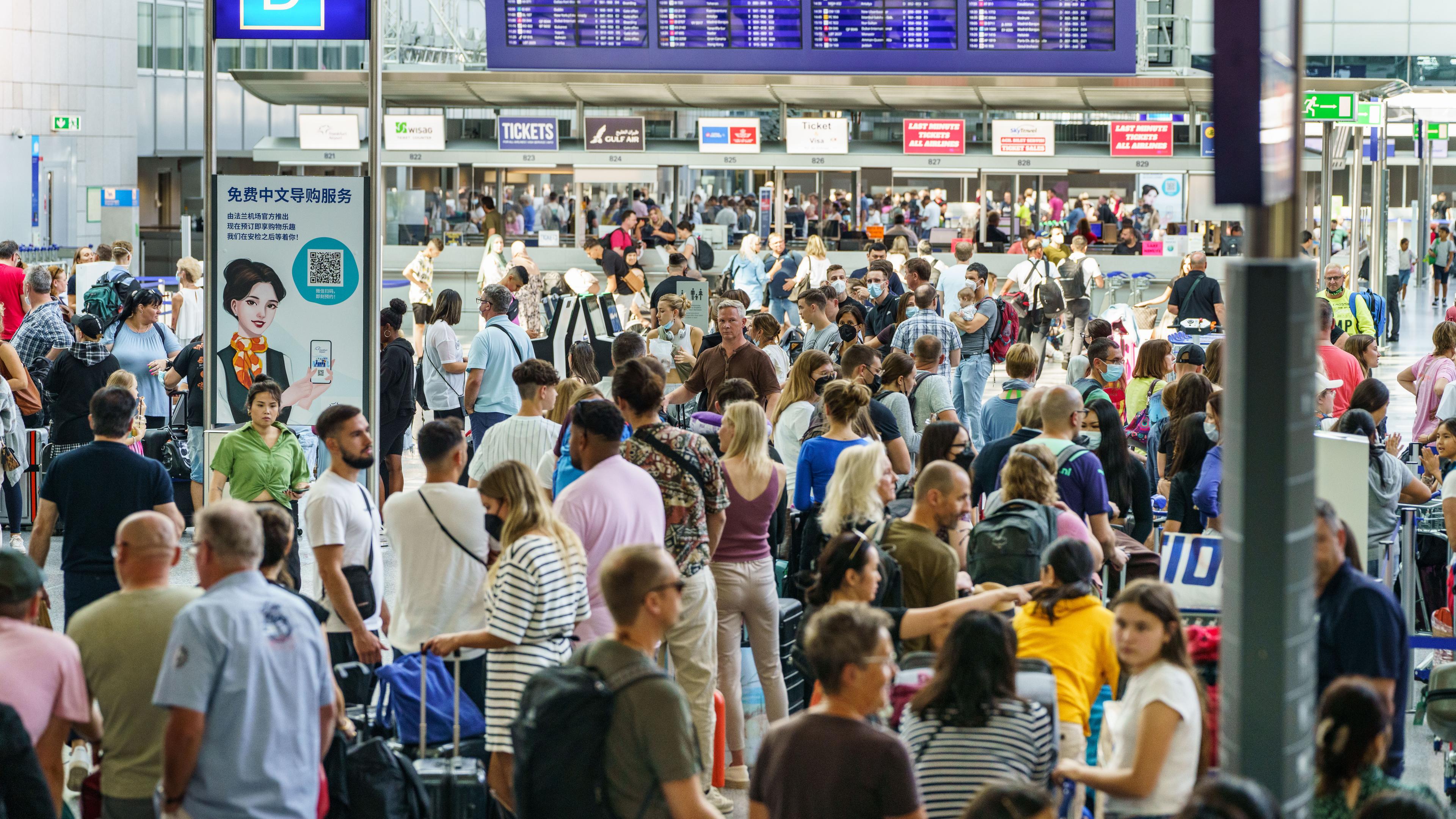 Hessen, Frankfurt/Main: Reisende warten dicht gedrängt im Terminal 2 des Frankfurter Flughafens am Check-In. Archivbild