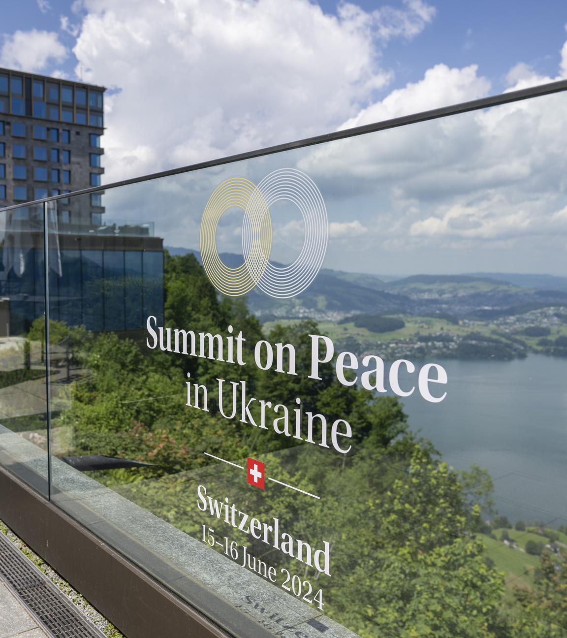 The logo and name of the 'Summit on Peace in Ukraine' is pasted onto a glass panel ahead of the Buergenstock conference at the Buergenstock Resort, in Obbeurgen, Switzerland, 13 June 2024. 