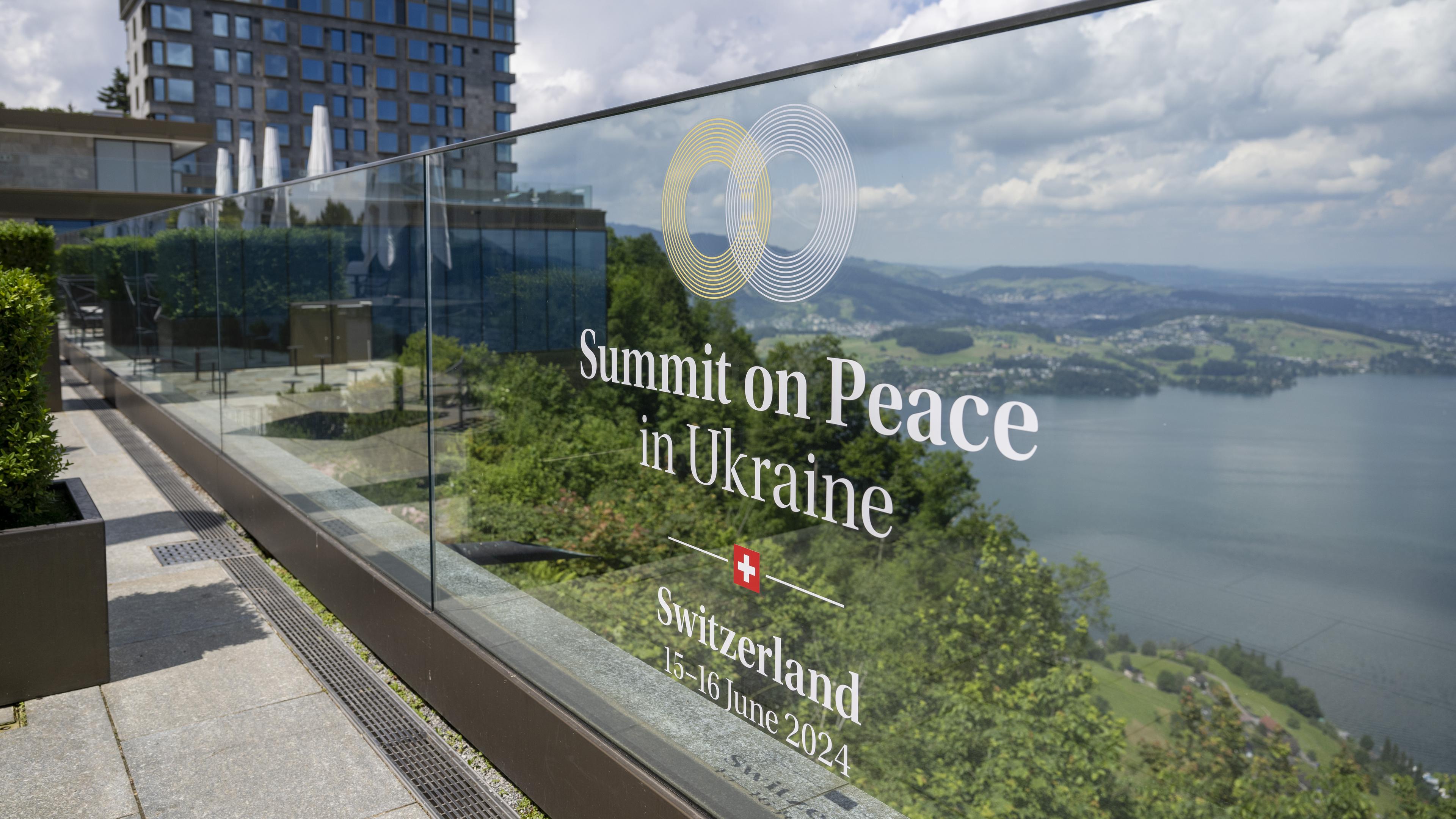 The logo and name of the 'Summit on Peace in Ukraine' is pasted onto a glass panel ahead of the Buergenstock conference at the Buergenstock Resort, in Obbeurgen, Switzerland, 13 June 2024. 