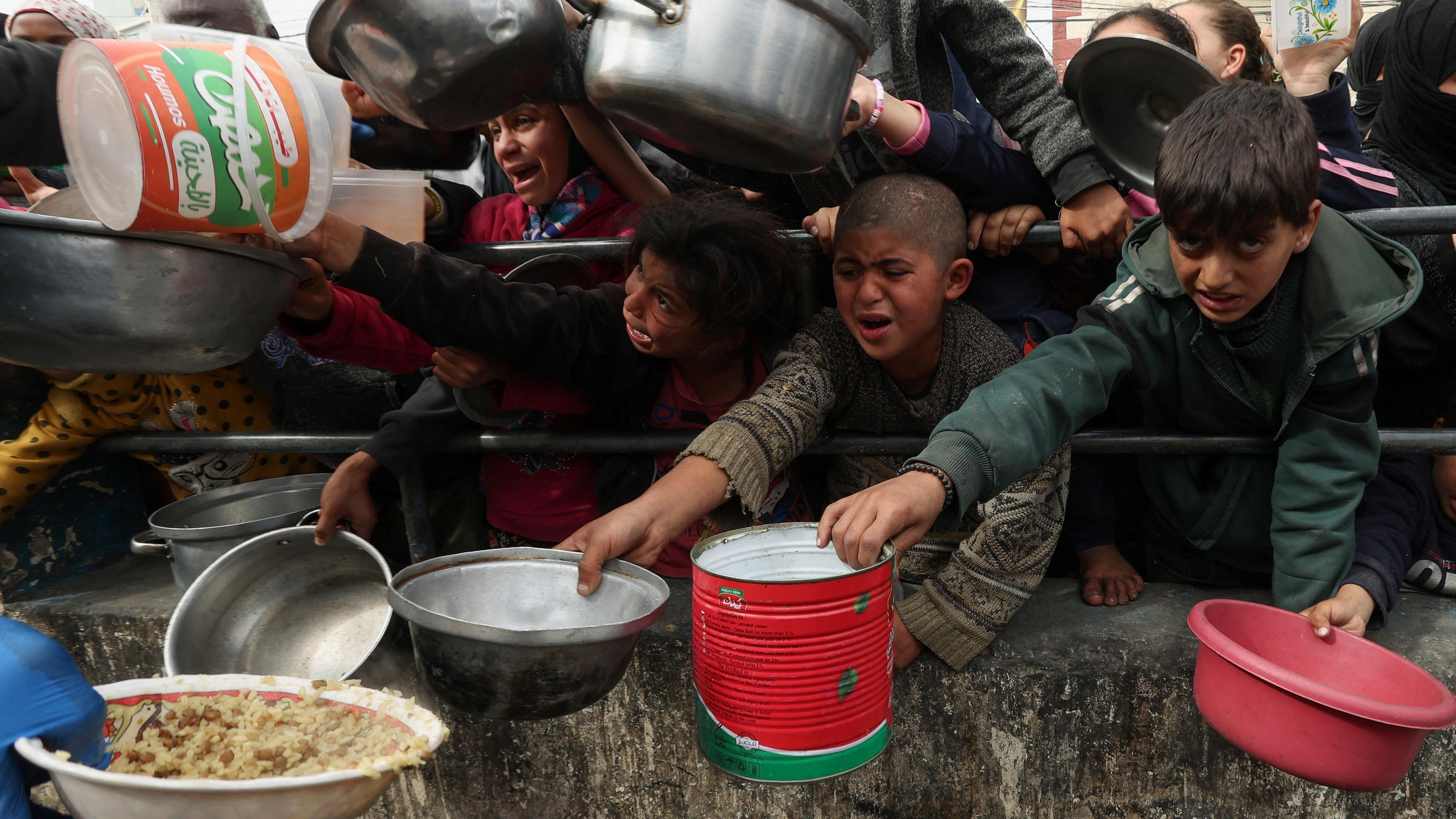 Palästinensische Kinder warten bei einer Essensausgabe in Rafah.
