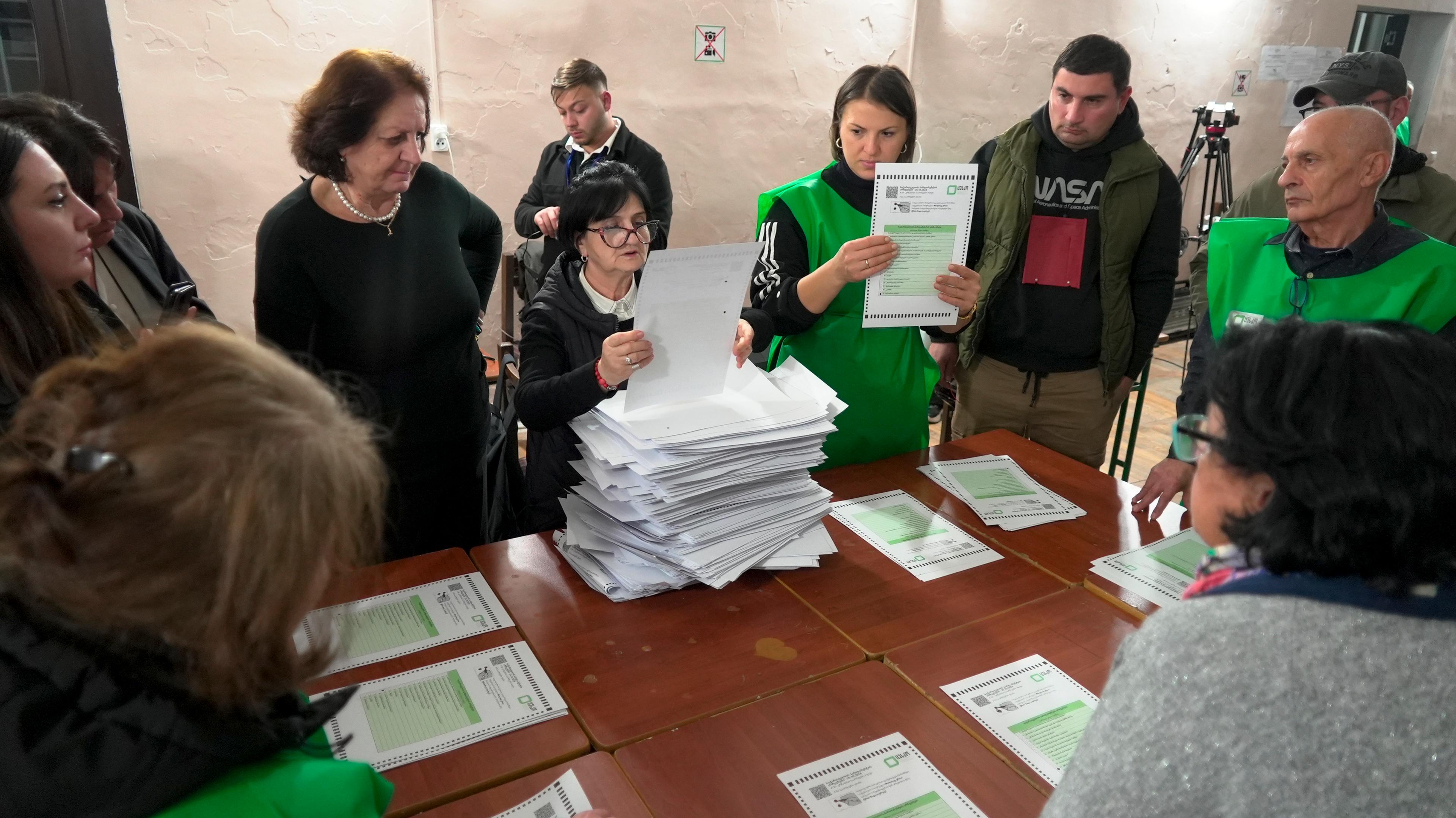 Mitglieder einer Wahlkommission zählen die Stimmzettel in einem Wahllokal in Tiflis nach den Parlamentswahlen in Georgien.