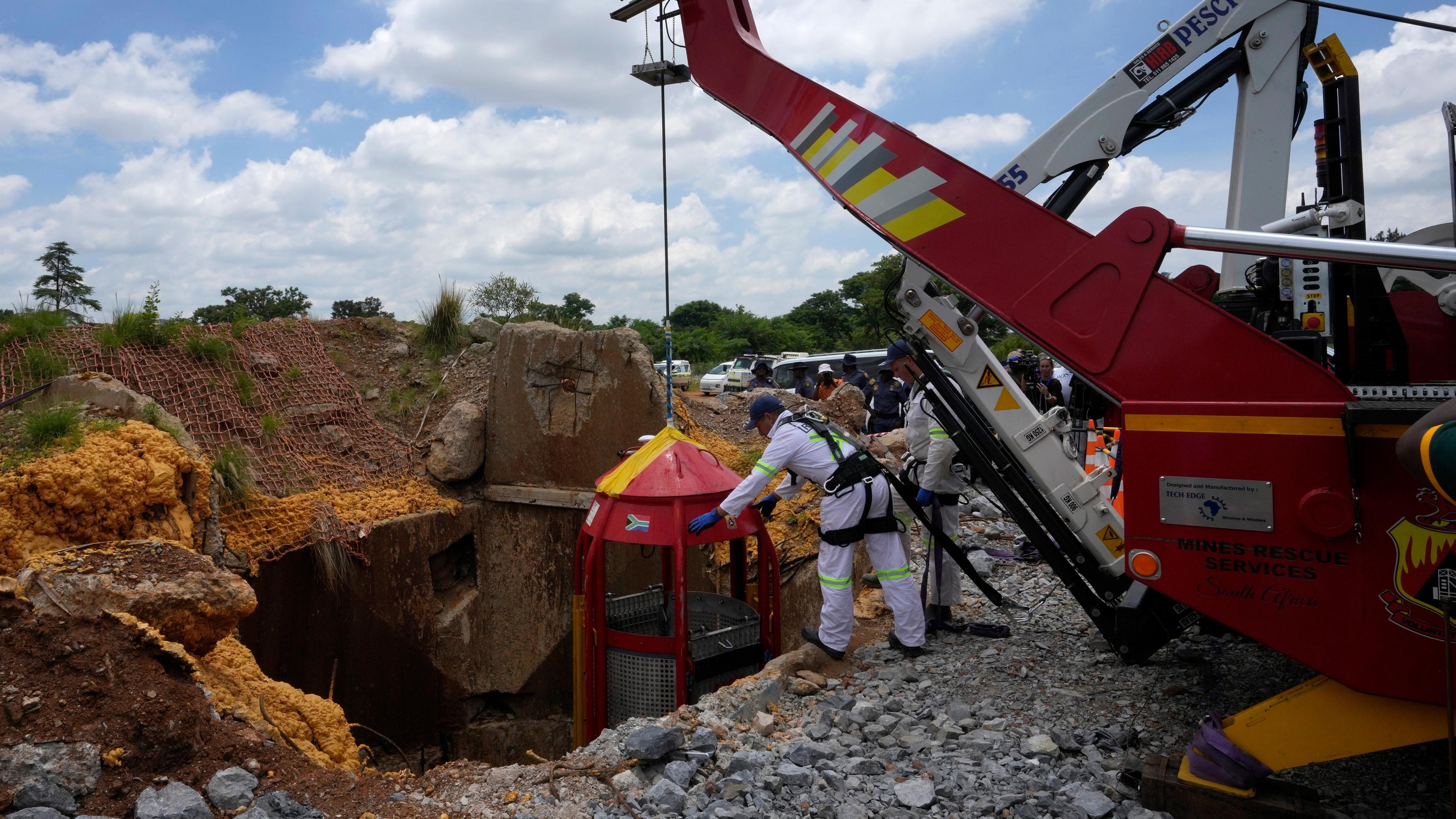 Helfer der Bergrettung ziehen einen Rettungskäfig aus dem Schacht einer illegalen Goldmine in Südafrika.