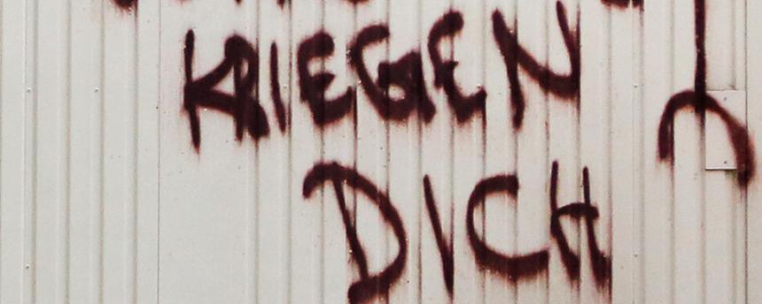 Bedrohliches Graffiti auf einem Baucontainer