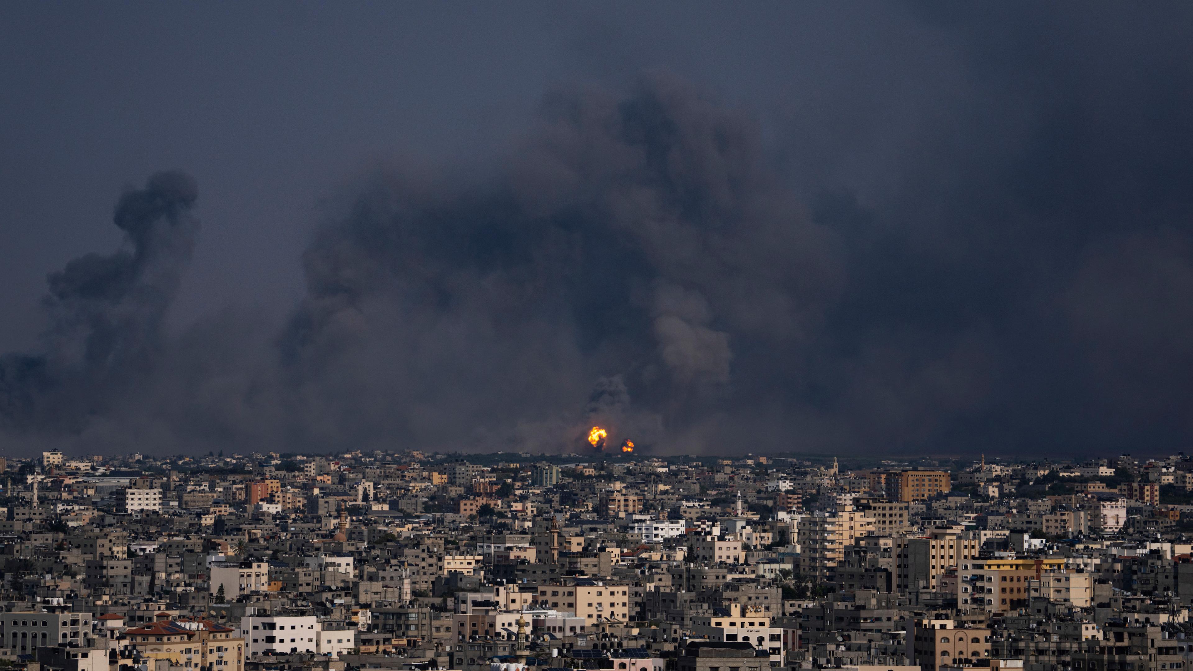 Fire and smoke rise following an Israeli airstrike, in Gaza City, Sunday, Oct. 8, 2023. 