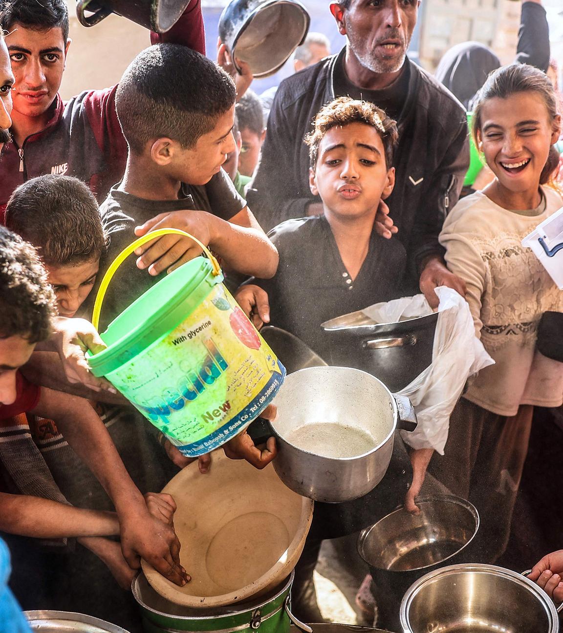 Palästinenser warten auf Nahrungsmittel im Flüchtlingslager Bureij im zentralen Gazastreifen, aufgenommen am  am 06.112024 