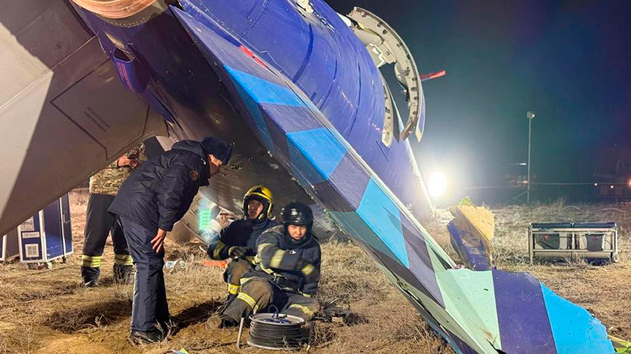 Männer arbeiten an einem abgestürzten Flugzeug in Kasachstan