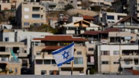     An Israeli flag flies on a roof near the so-called Alpha Line, which separates the Israeli-controlled Golan Heights from Syria.