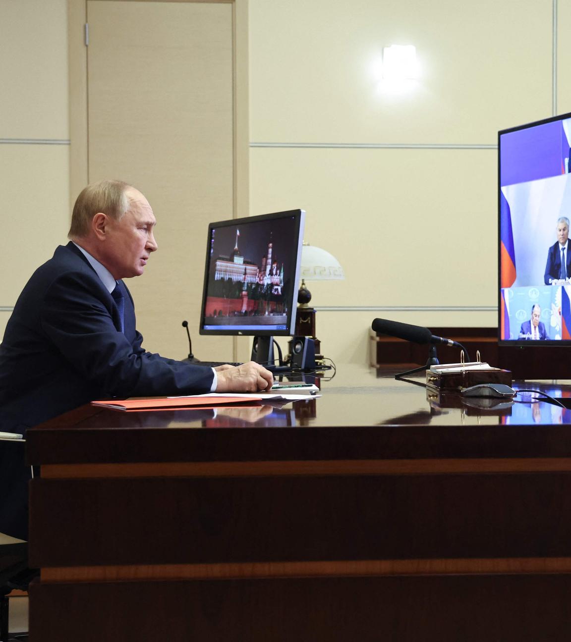 In this pool photograph distributed by the Russian state agency Sputnik, Russia's President Vladimir Putin chairs a Security Council