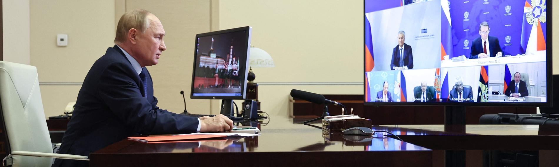 In this pool photograph distributed by the Russian state agency Sputnik, Russia's President Vladimir Putin chairs a Security Council