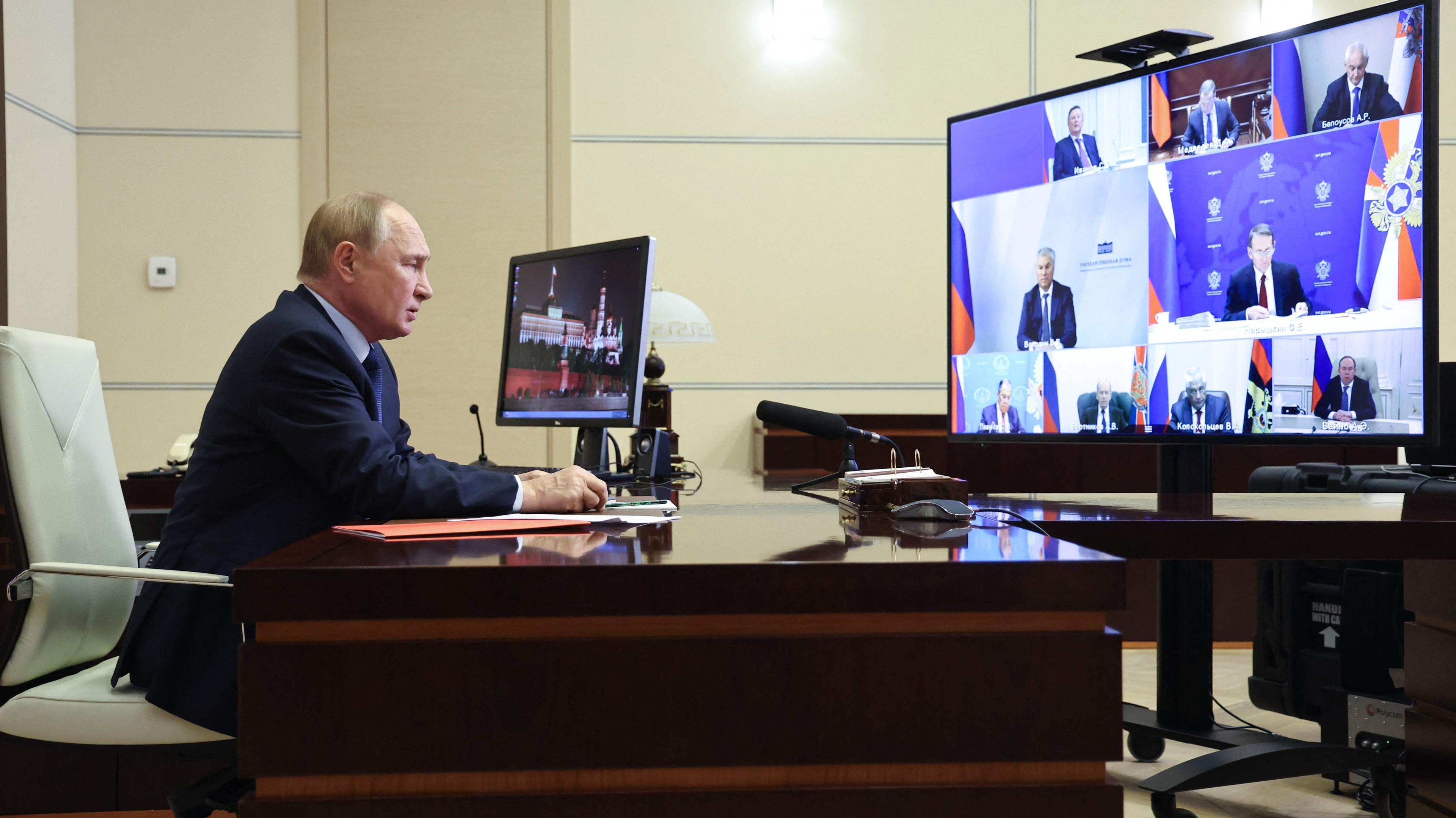 In this pool photograph distributed by the Russian state agency Sputnik, Russia's President Vladimir Putin chairs a Security Council