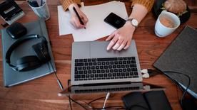 A woman works on the laptop