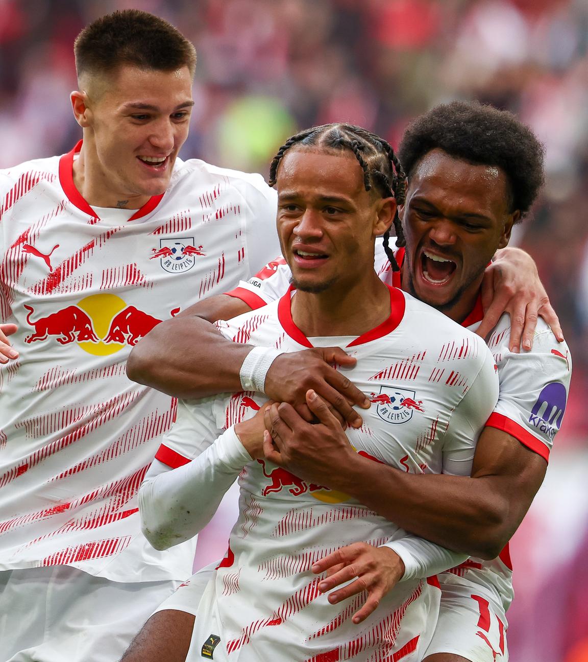 Leipzigs Torschützen Benjamin Sesko (l-r), Lois Openda und Xavi Simons jubeln nach Simons Treffer zum 4:0.