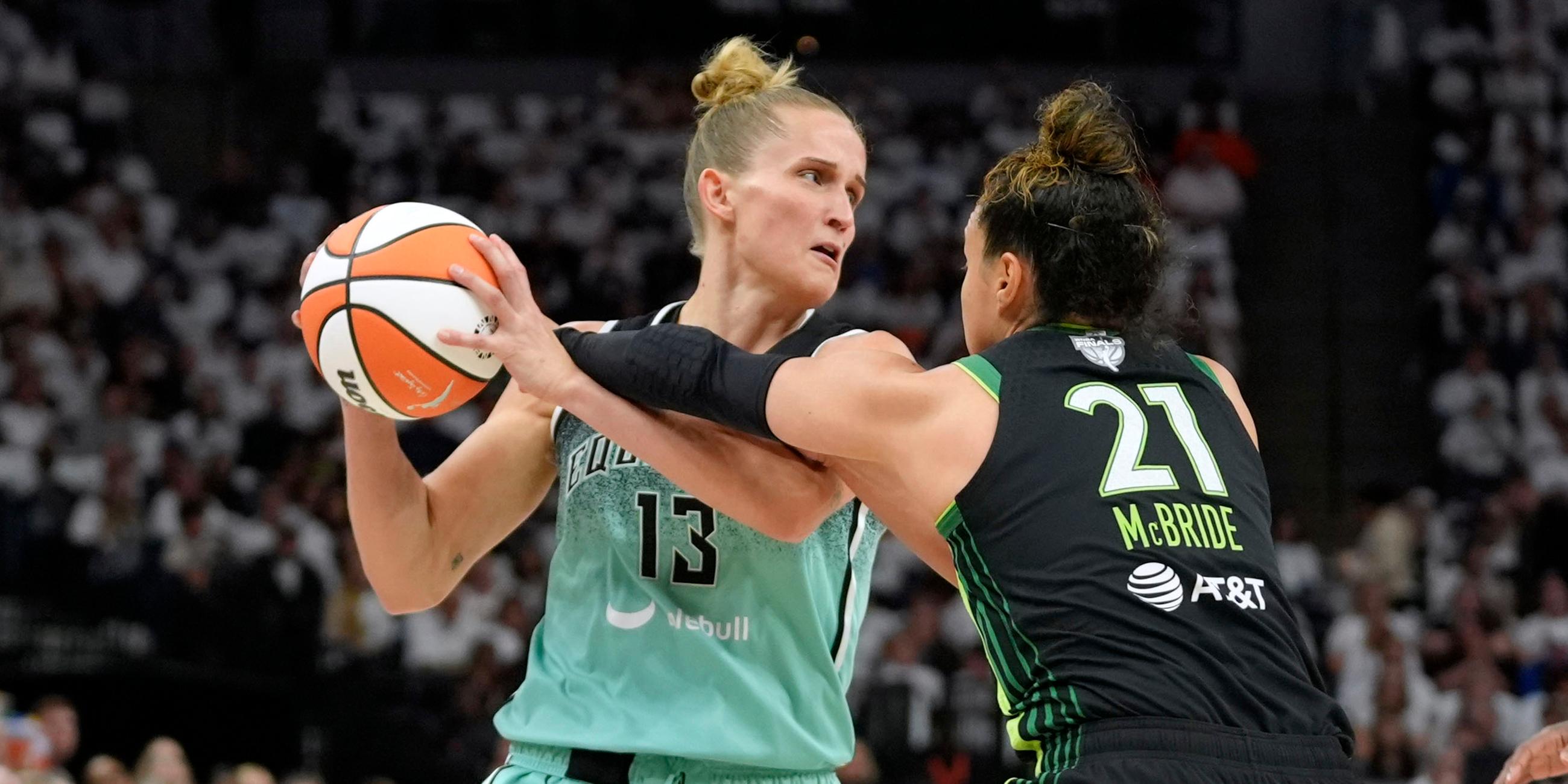 Minnesota Lynx-Guard Kayla McBride (21) versucht, der New York Liberty-Stürmerin Leonie Fiebich (13) in der ersten Halbzeit von Spiel 3 einer WNBA-Basketball-Final-Playoff-Serie am Mittwoch, 16. Oktober 2024, in Minneapolis den Ball zu stehlen. 