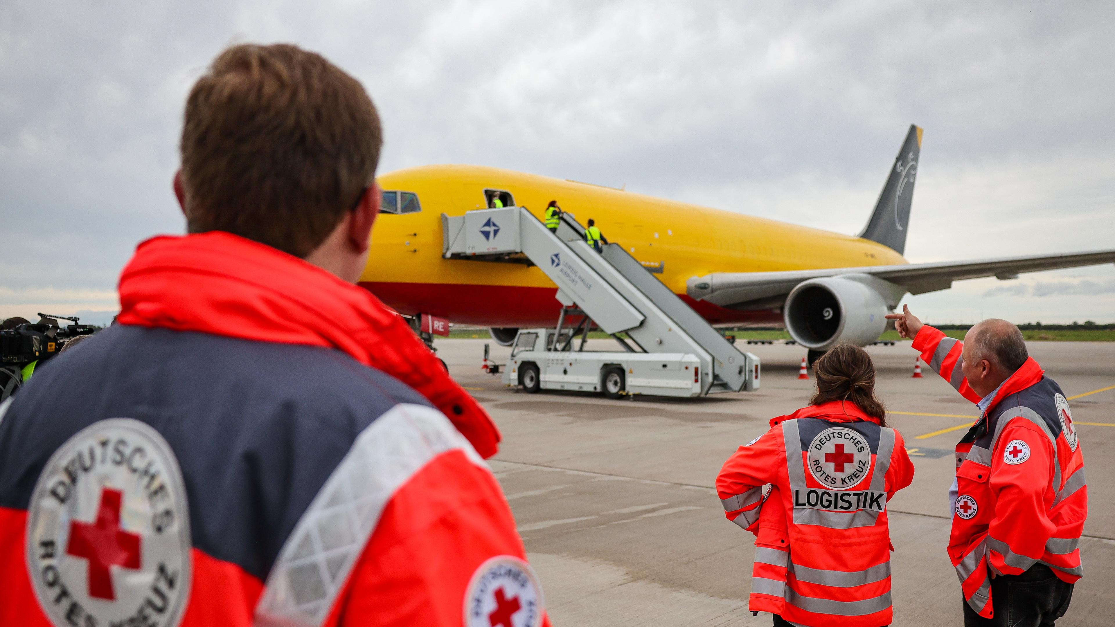 Sachsen, Schkeuditz: Mitarbeiter des Deutschen Roten Kreuzes (DRK) überwachen die Beladung eines Flugzeuges mit Hilfsgütern für Libyen.