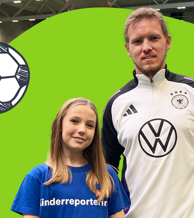 logo!-Kinderreporterin Daliah steht mit Julian Nagelsmann in einer Sporthalle mit grünem Kunstrasen.