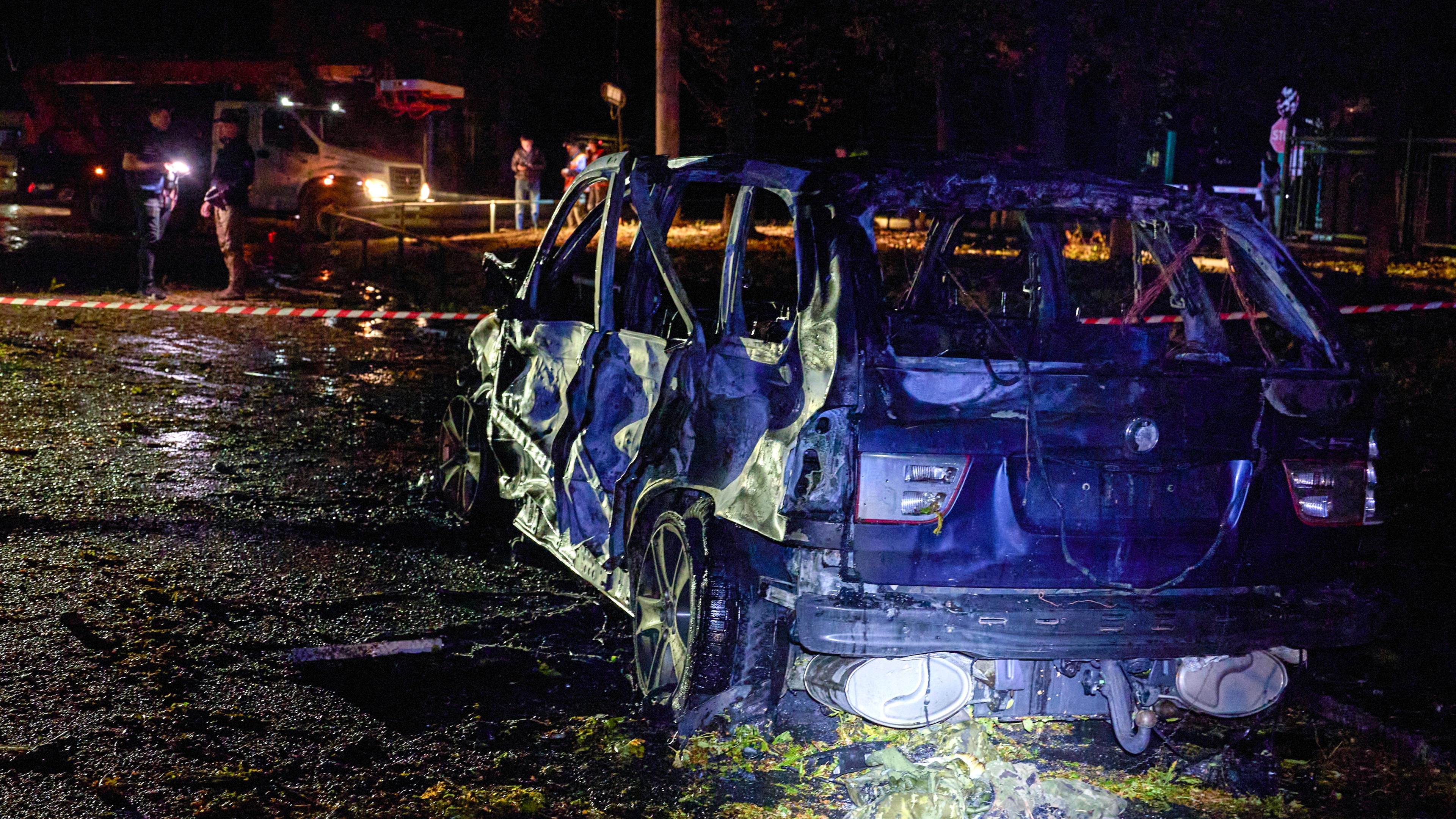 A burned car at the site of a shelling in Kharkiv, Ukraine, late 20 September 2024, amid the ongoing Russian invasion.