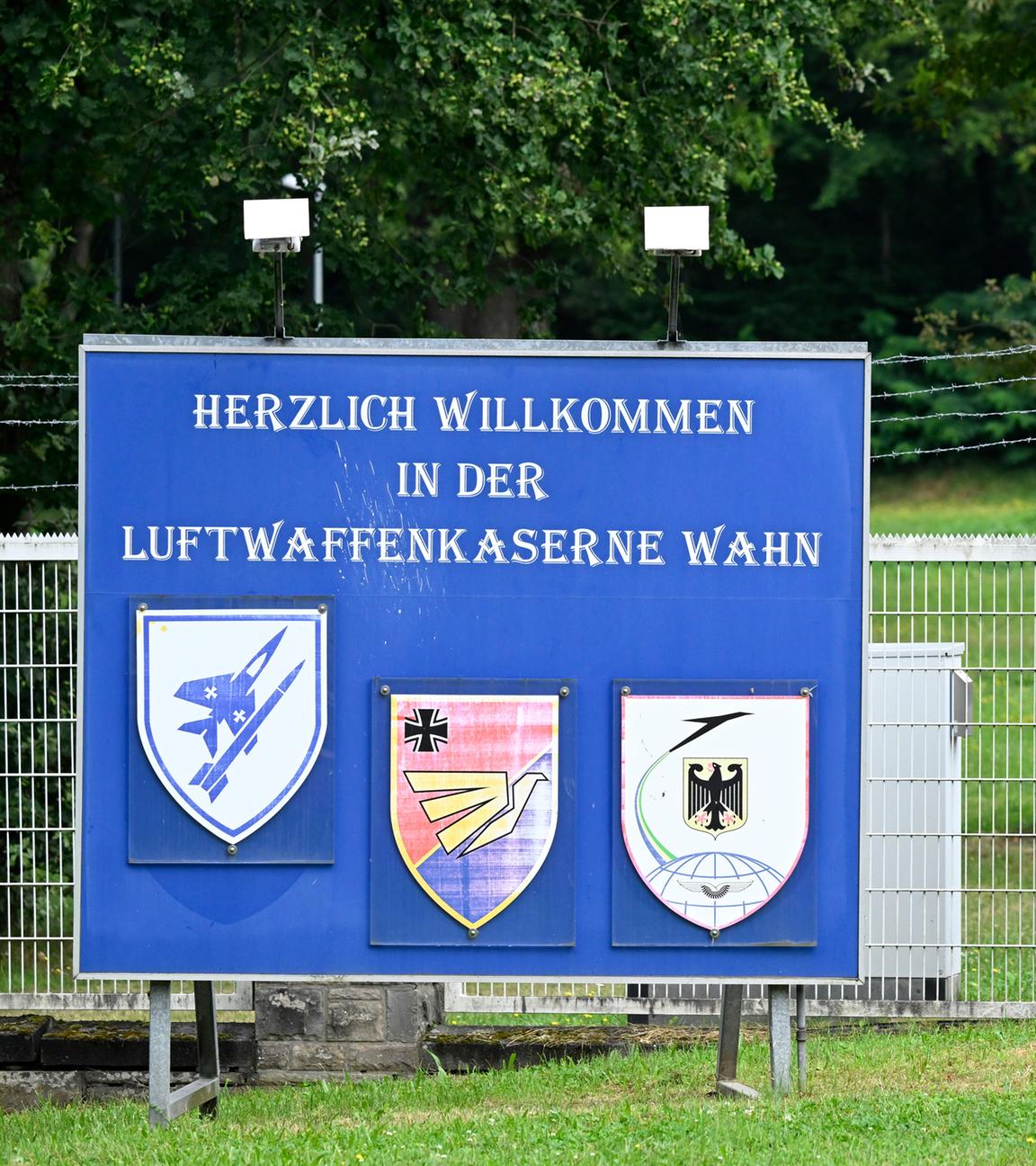 Ein Schild steht am Eingang zur Luftwaffenkaserne in Wahn und dahinter ein kleines Flugzeug