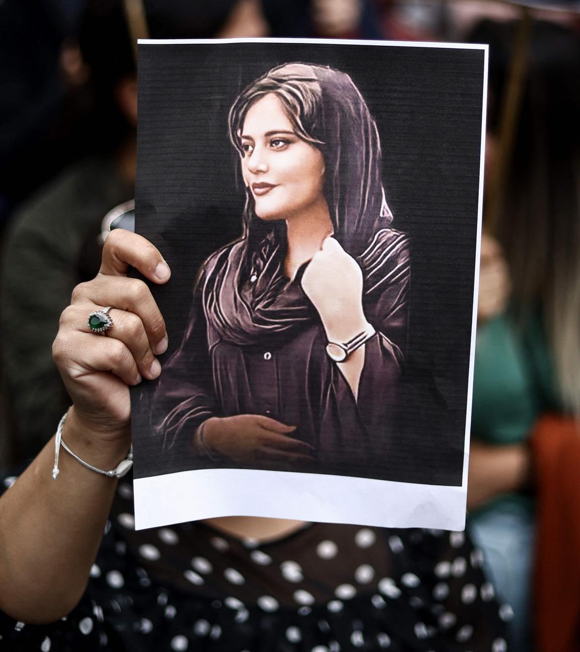 Ein Demonstrant hält ein Porträt von Mahsa Amini während einer Demonstration zu ihrer Unterstützung vor einer iranischen Botschaft