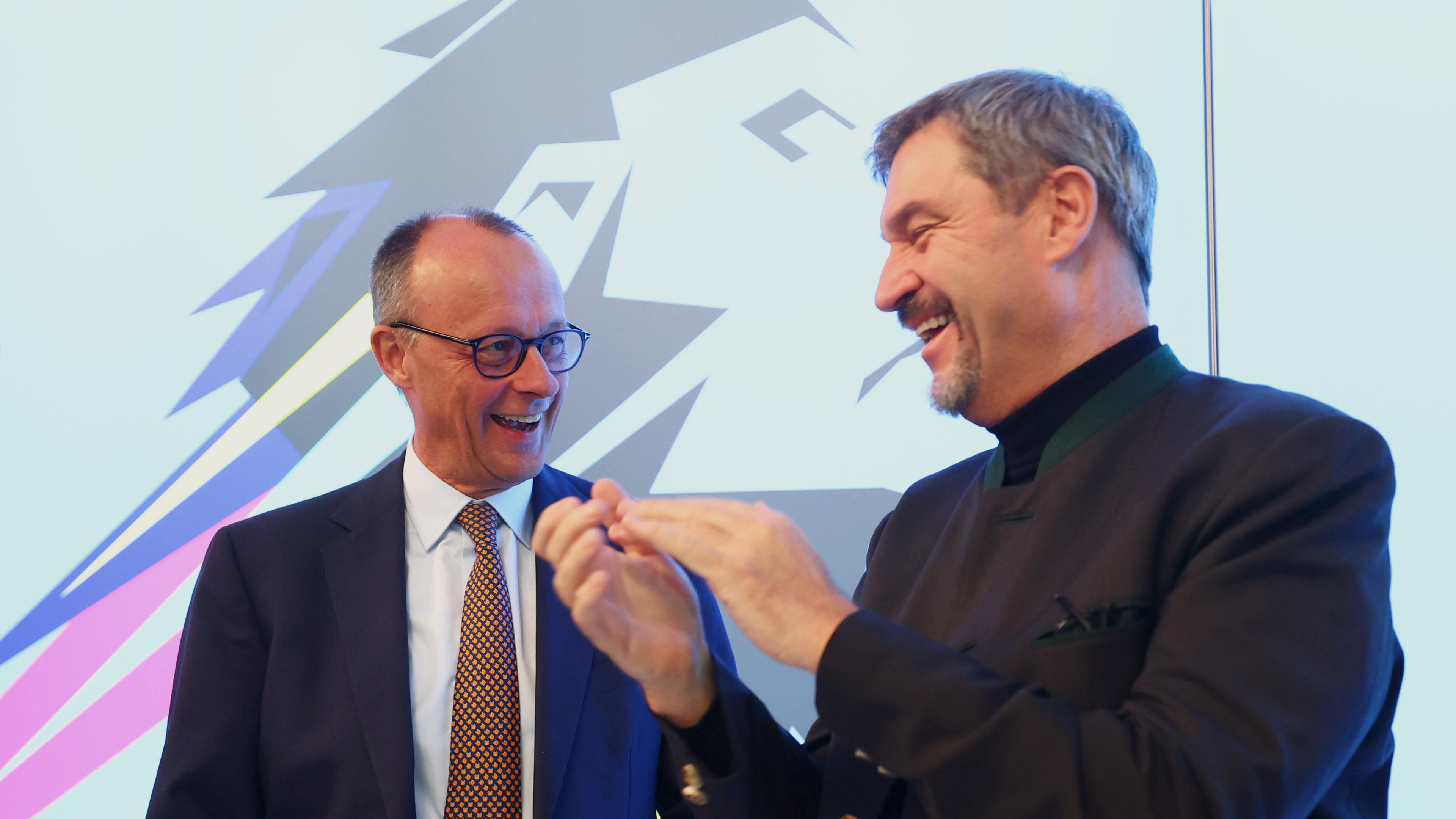 State Premier of Bavaria and Christian Social Union (CSU) chairman Markus Soeder (R) and Chairman of Germany's Christian Democratic Union (CDU) Friedrich Merz (L) react as they attend the CSU closed-door meeting at the Seeon Monastery in Seeon-Seebruck, Germany, 08 January 2025.