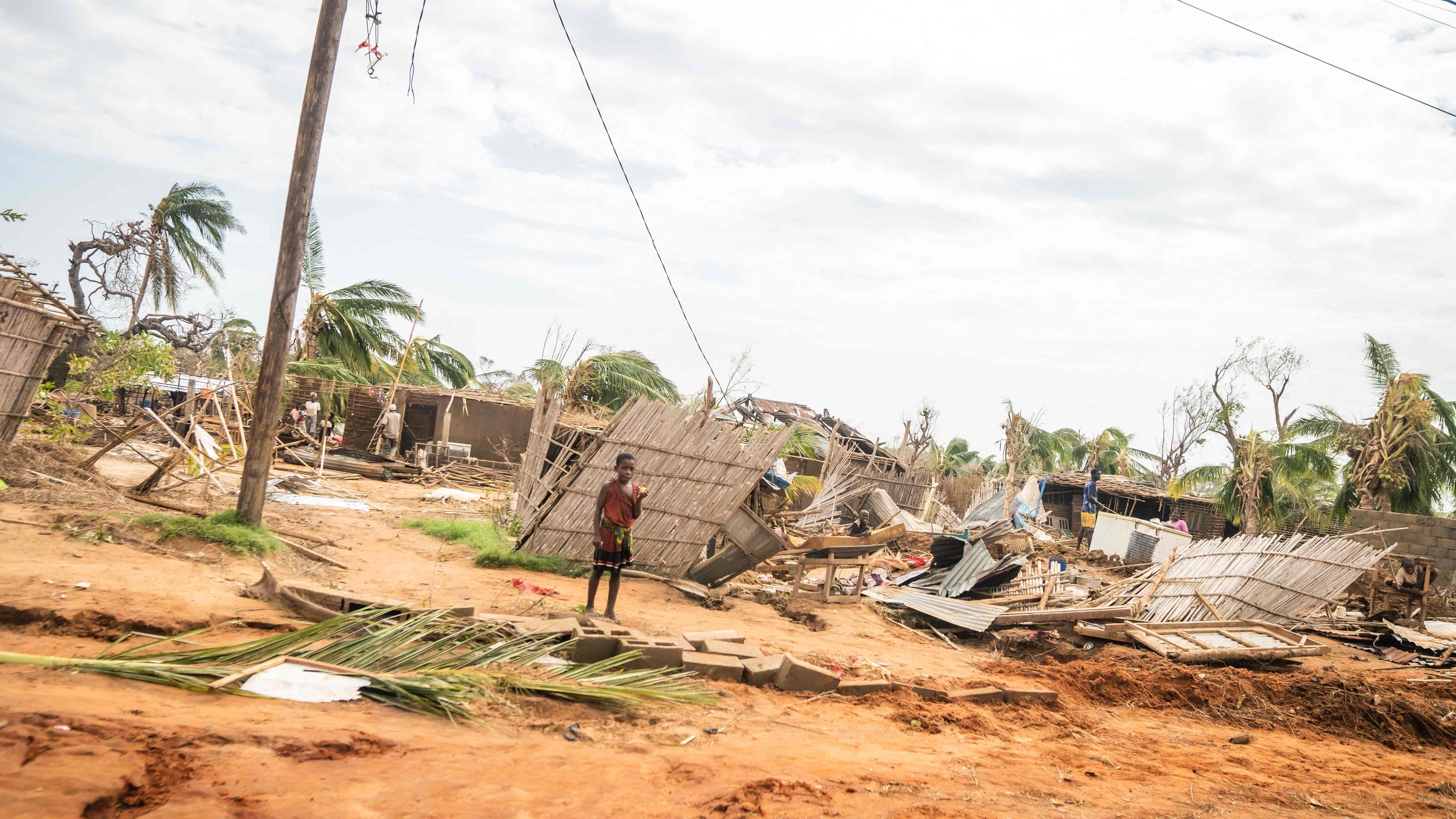  A child standing next to damaged homes after Cyclone Chido made its landfall in Mecufi district.