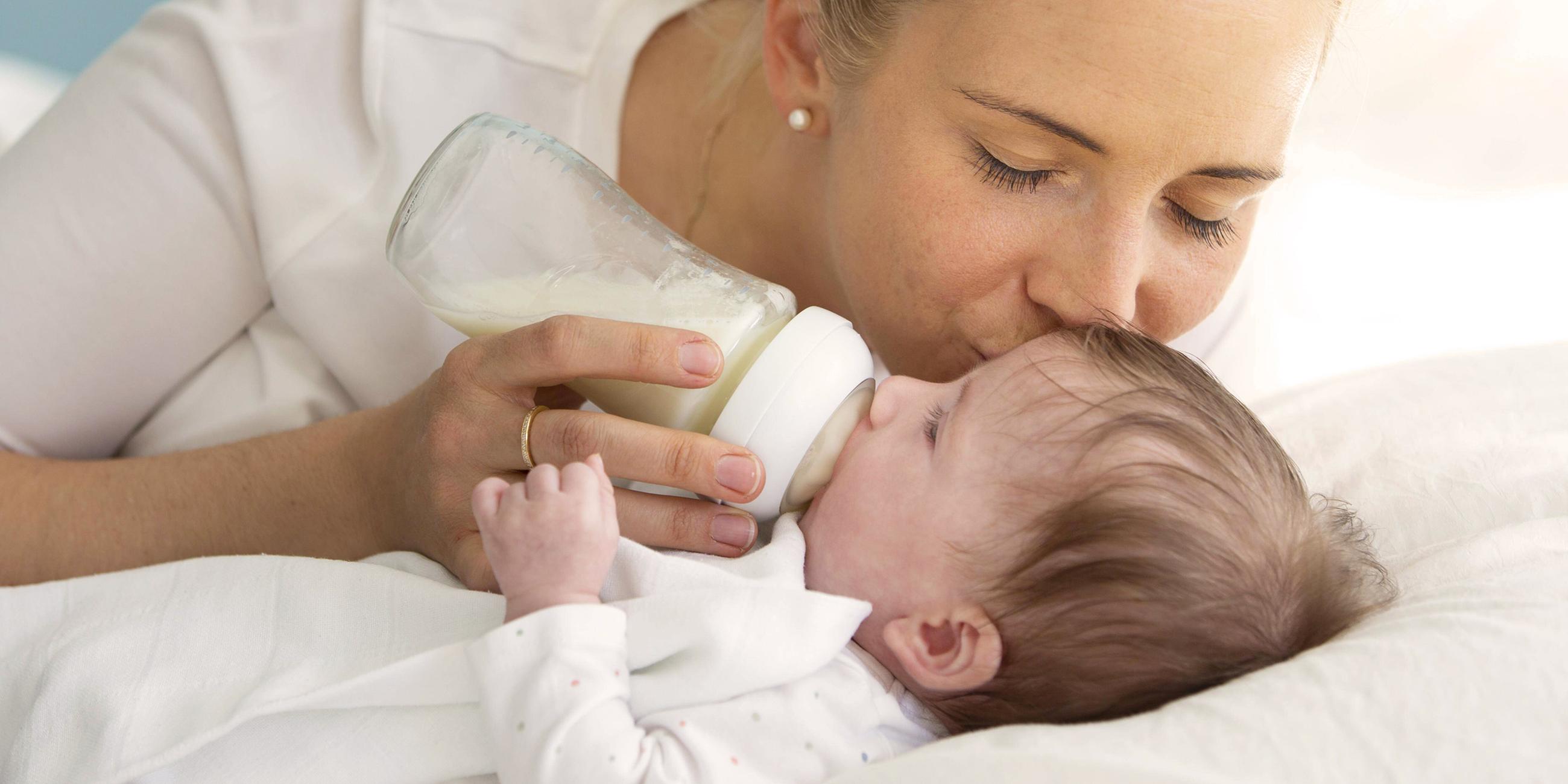 Mutter füttert ihr Baby mit einer Flasche