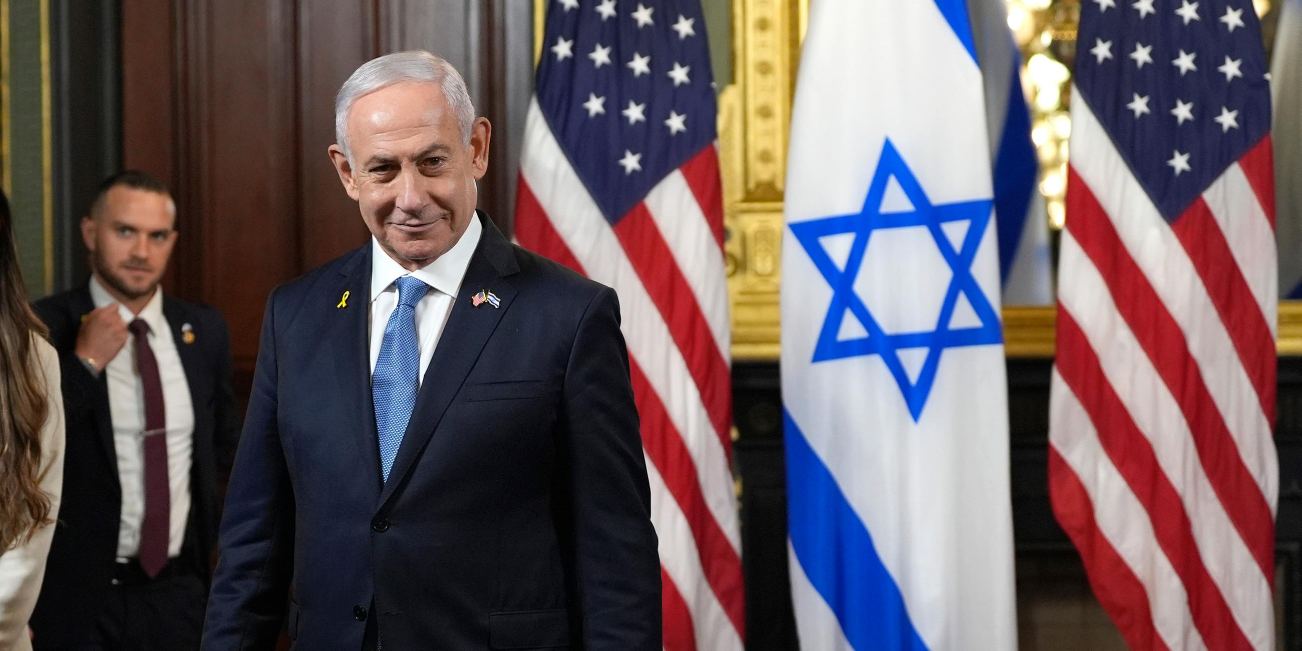 Der israelische Ministerpräsident Benjamin Netanjahu steht vor der israelischen und amerikanischen Flaggen  im Eisenhower Executive Office Building im Weißen Haus.