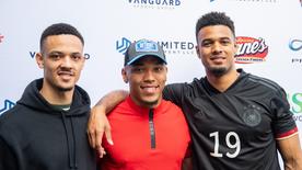 USA, Lake Forest: Football player Amon-Ra St. Brown (M) stands between his brothers Osiris (l) and Equanimeous after being selected at the NFL Draft