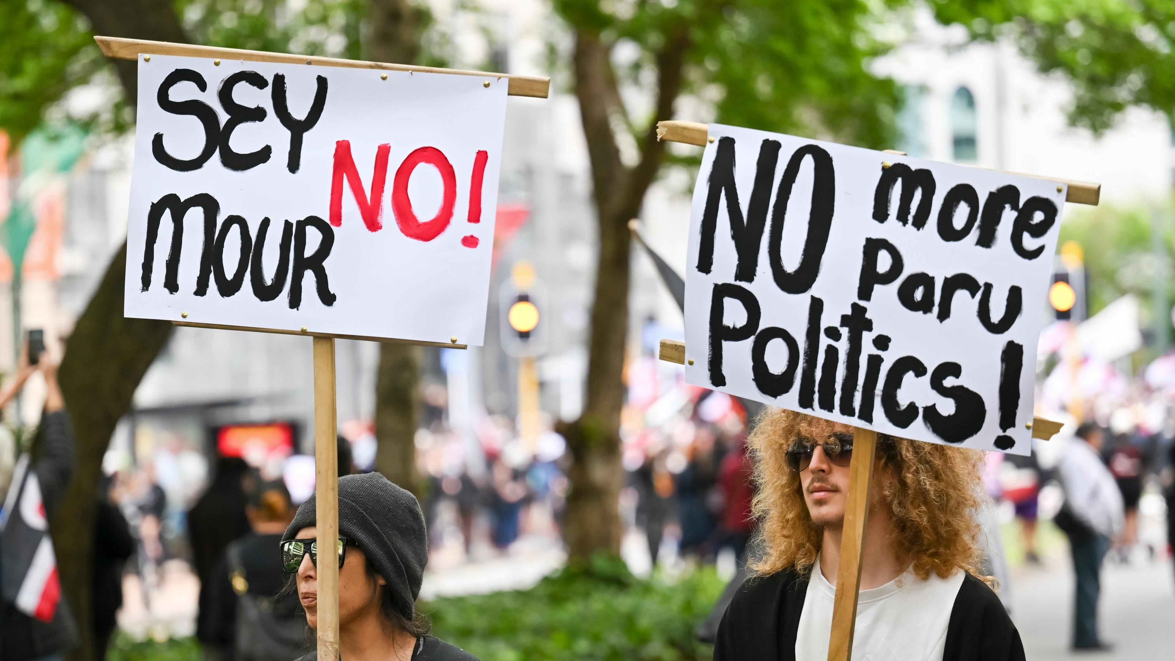 Protesters march carrying placards to New Zealand's parliament to demonstrate against a proposed law that would redefine the country's founding agreement between Indigenous Maori and the British Crown, in Wellington, New Zealand, Tuesday, Nov. 19, 2024. (AP Photo/Mark Tantrum)