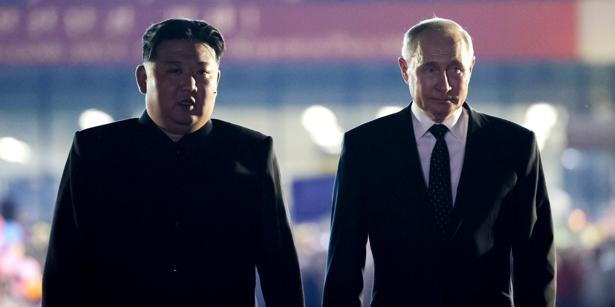 Russian President Vladimir Putin, right, and North Korea's leader Kim Jong Un stand together during the departure ceremony at an international airport outside Pyongyang, North Korea, on Wednesday, June 19, 2024.