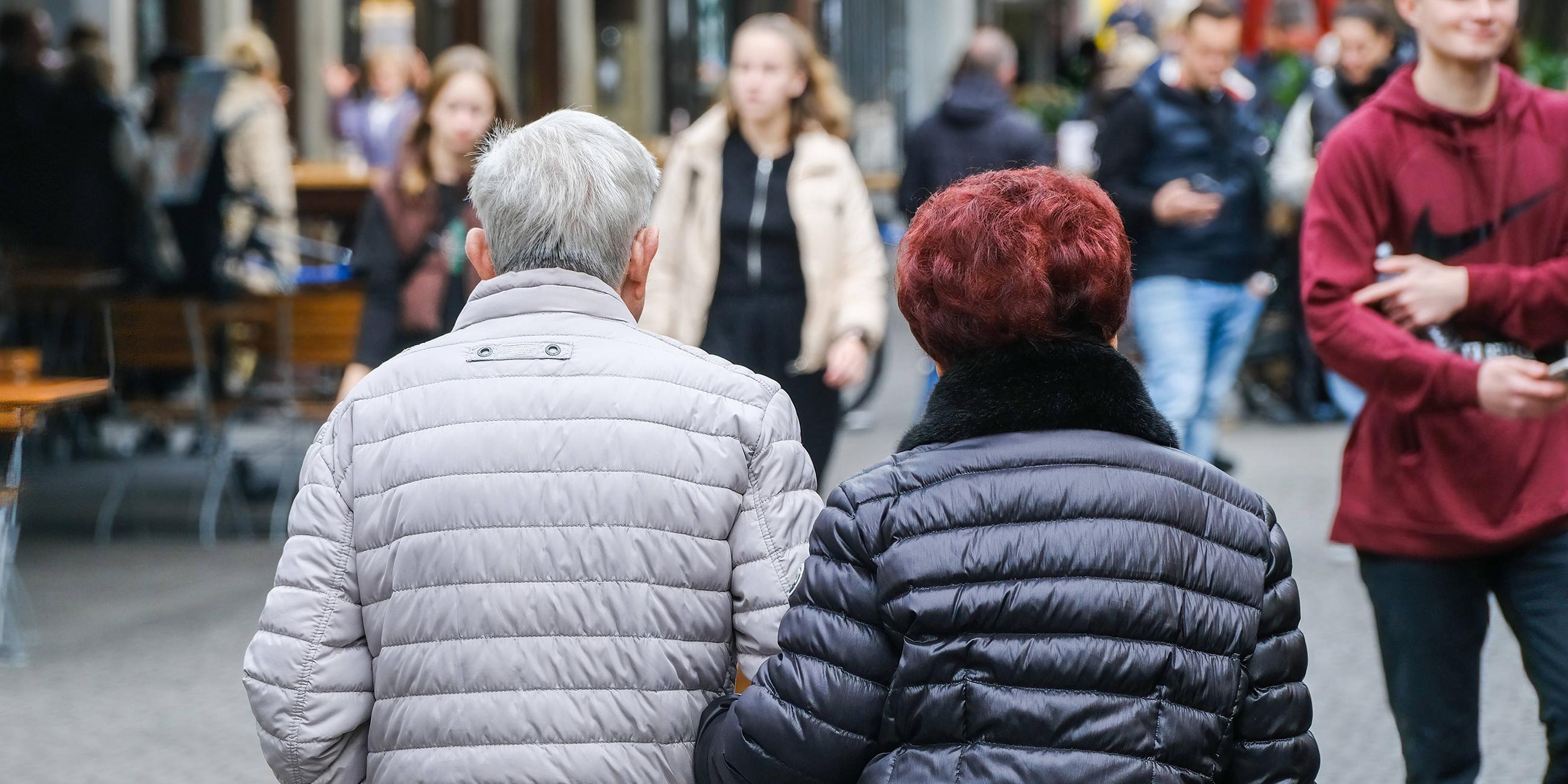 Älteres Ehepaar in der Fußgängerzone von hinten