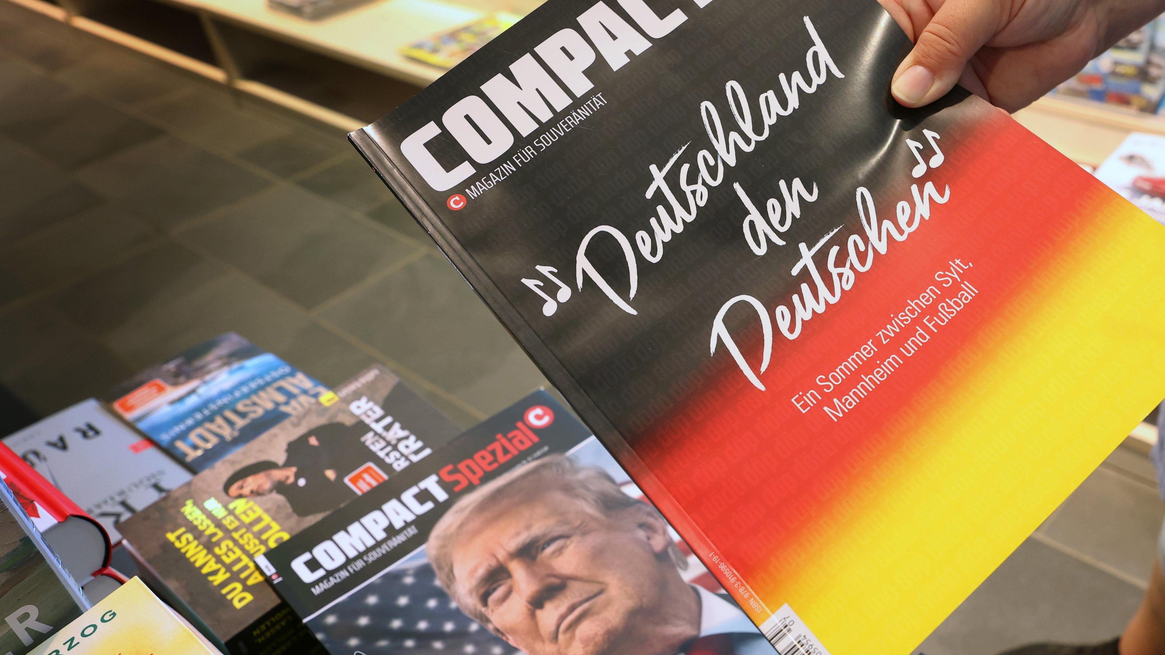 Bayern, Kempten: Eine Mitarbeiterin einer Bahnhofsbuchhandlung hält eine Ausgabe des Magazins "Compact", um es danach aus dem Sortiment zu nehmen.