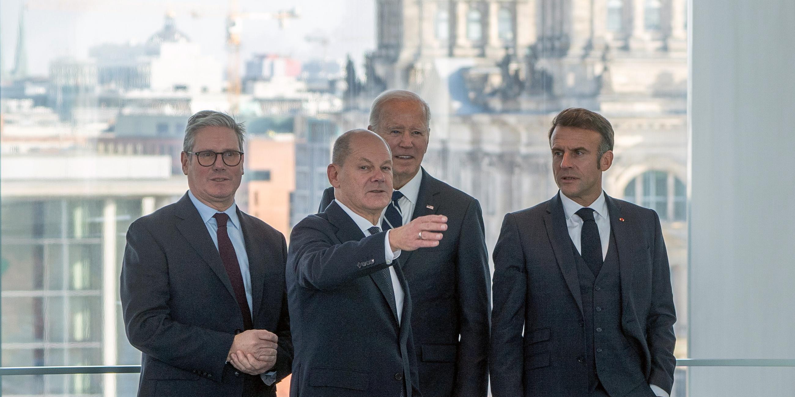 ritish Prime Minister Keir Starmer, German Chancellor Olaf Scholz, US President Joe Biden and French President Emmanuel Macron attend a joint meeting in front of the Reichstag Building in Berlin