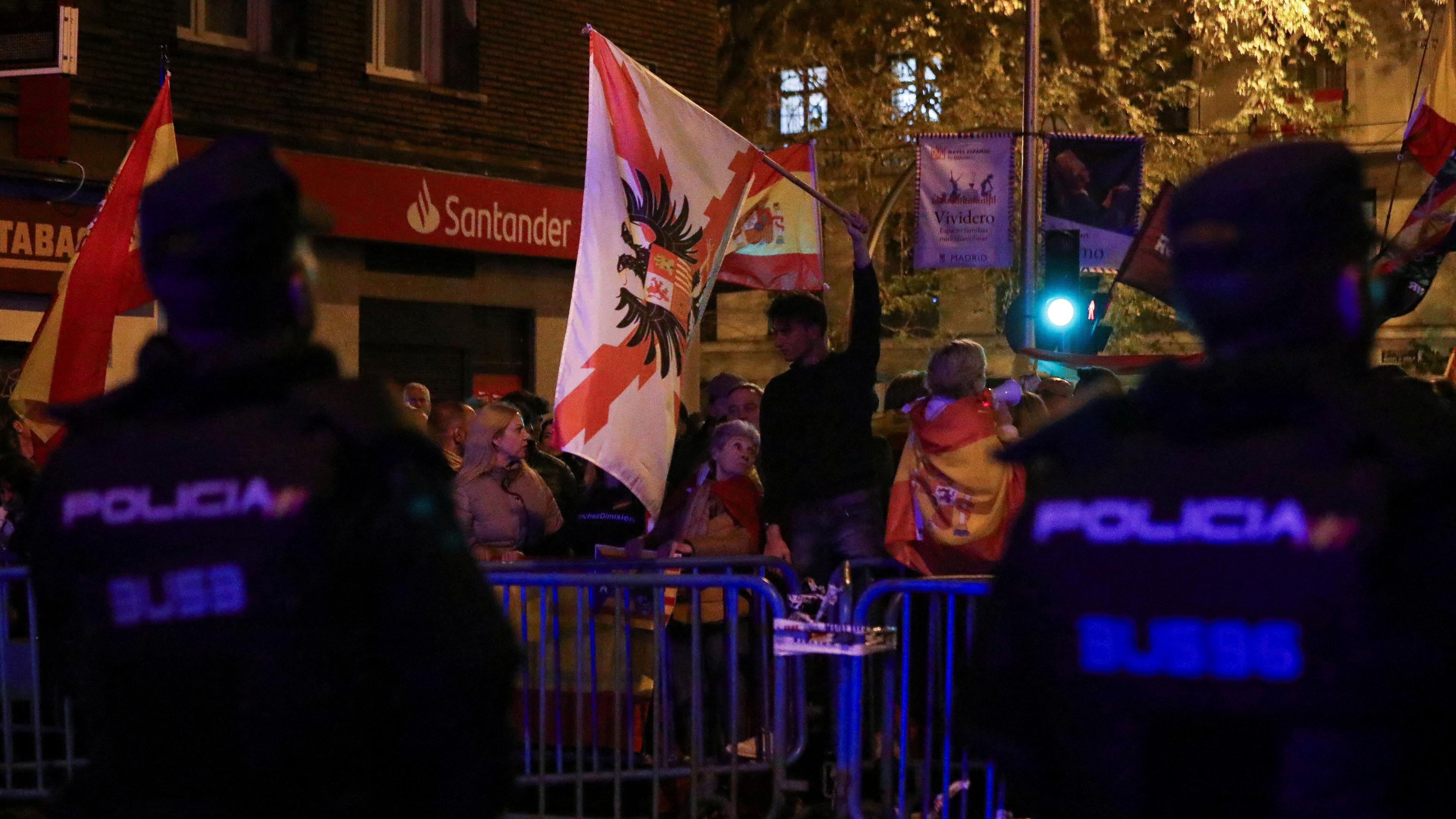 Riot police stand guard as people protest near Spain's Socialist Party (PSOE) headquarters, after Spain's socialists reached a deal with the Catalan separatist Junts party for government support, a pact which involves amnesties for people involved with Catalonia's failed 2017 independence bid, in Madrid, Spain November 13, 2023.