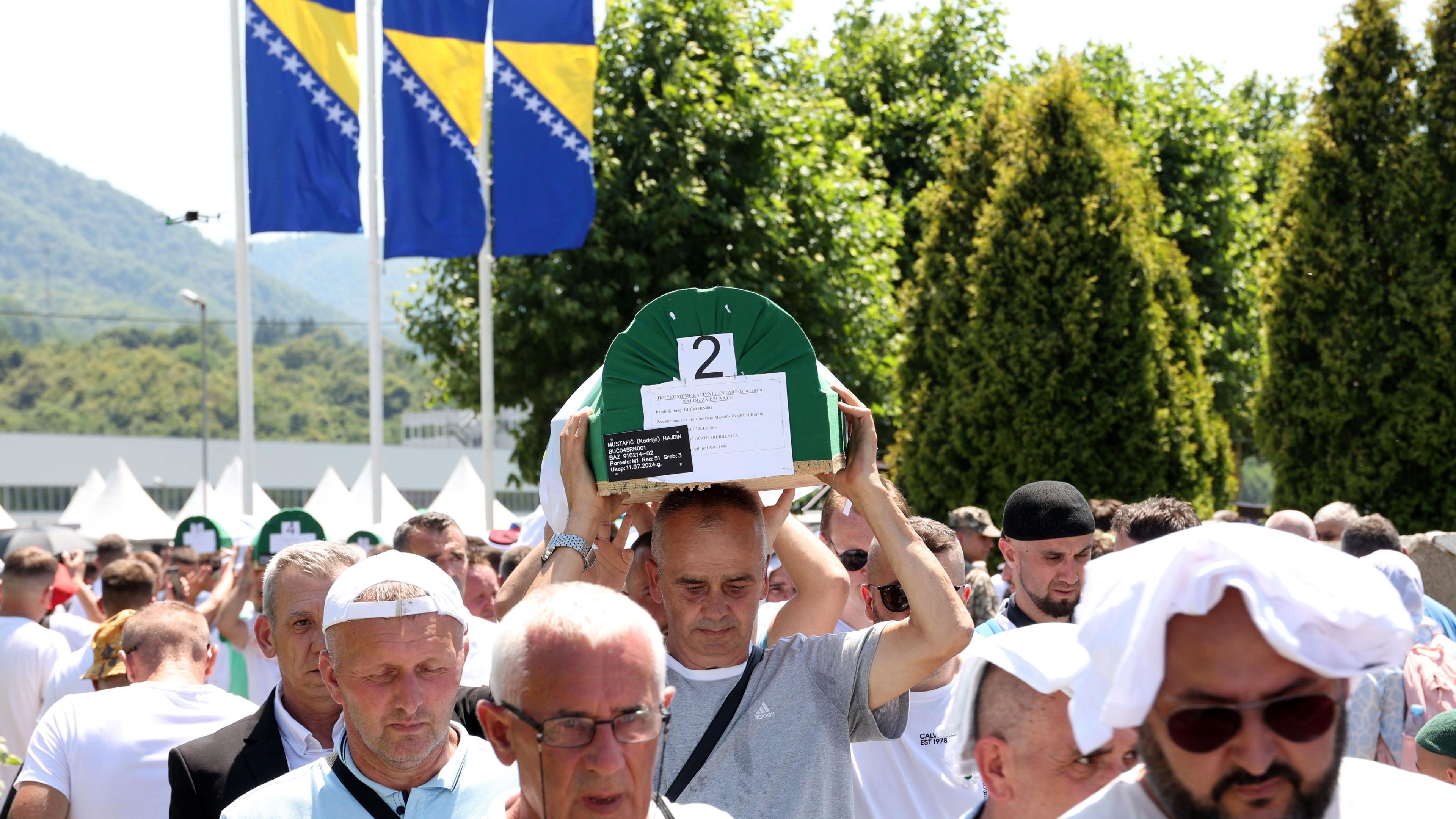 Bosnian Muslims carry caskets with the remains of eleven newly-identified Bosnian Muslim victims of Srebrenica genocide, during a funeral ceremony at the Potocari Memorial Center and Cemetery, in Srebrenica, Bosnia and Herzegovina, 11 July 2024.